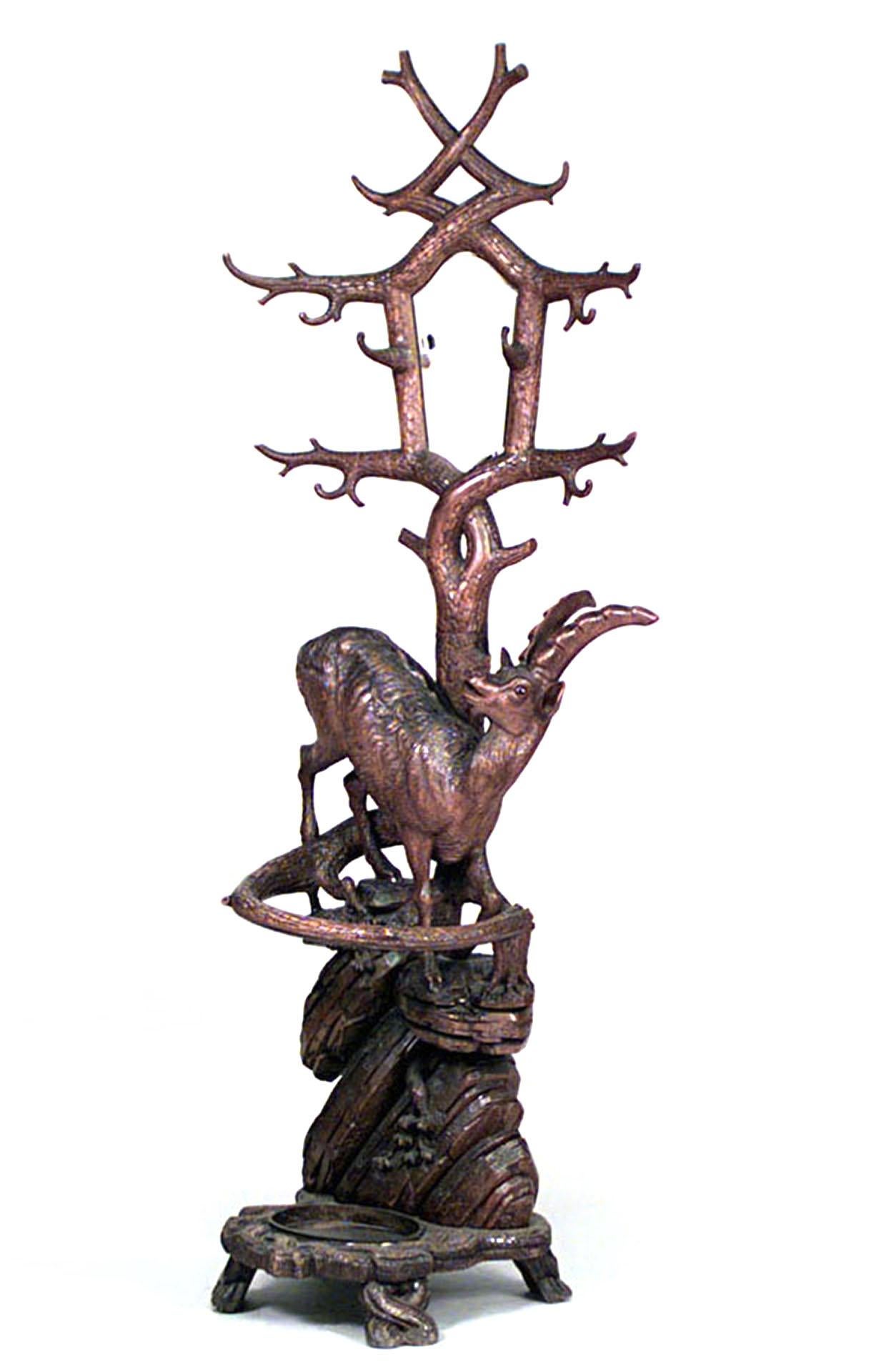 Rustic Black Forest (19th Century) carved walnut hatrack/umbrella stand with deer figure on base and mirror on upper section.
