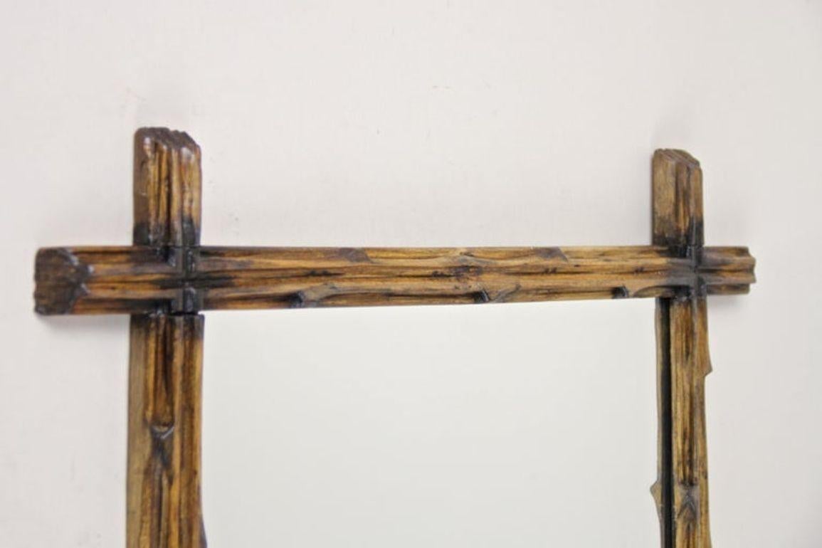 Hand-Carved 19th Century Rustic Black Forest Wall Mirror with Black Accents, AT, circa 1890 For Sale