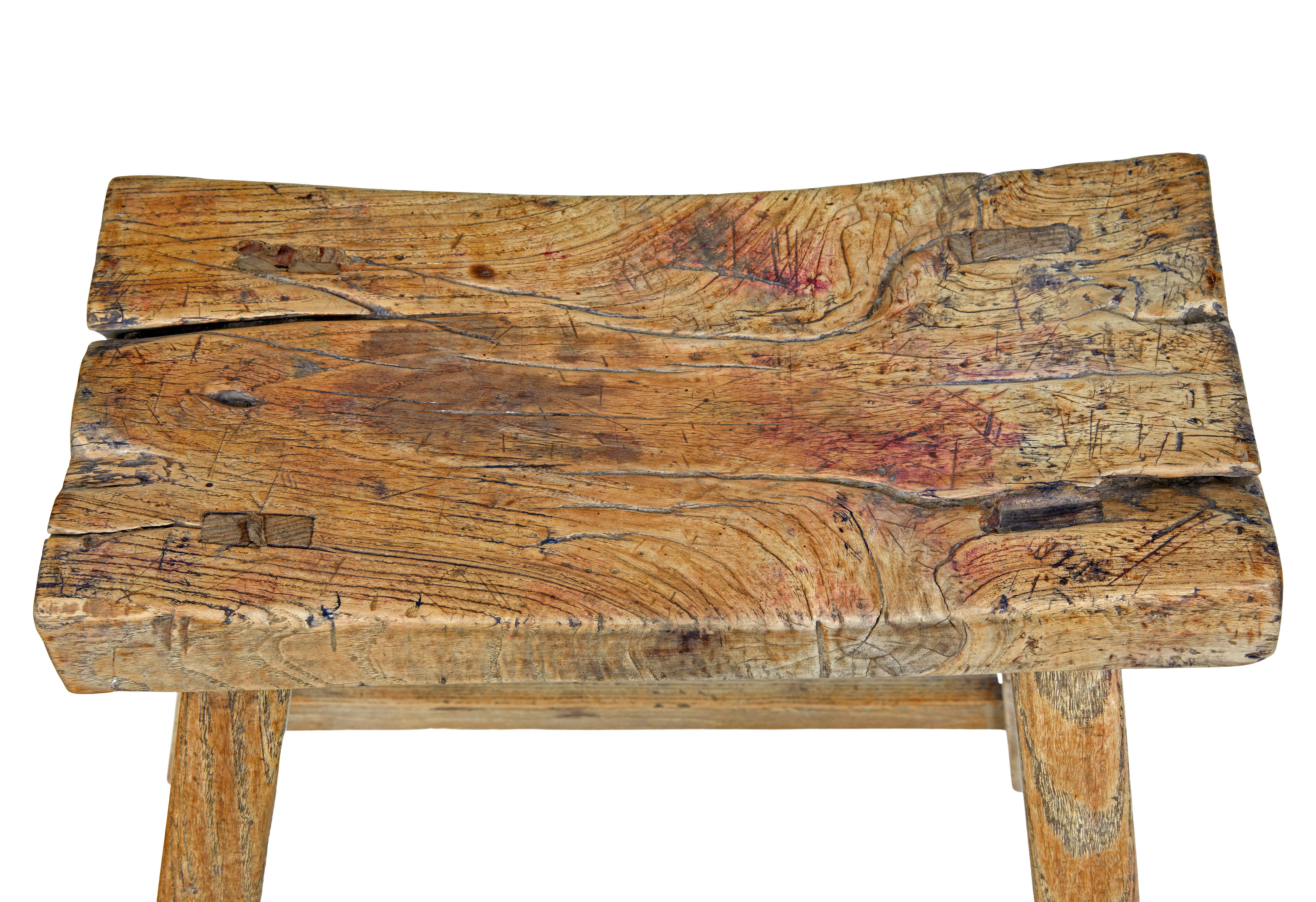 19th century rustic chinese hardwood stool circa 1890.

Shaped hardwood seat, made with character wood showing the knots and splits.  Standing on 4 legs united by stretchers.  Ideal for use as a side table as well as for seating.

Expected surface