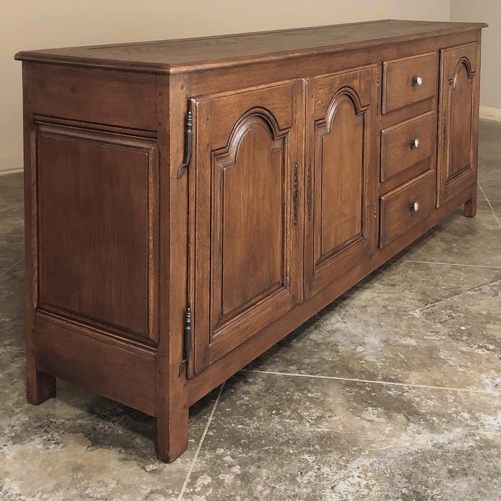19th century Rustic Country French credenza ~ Buffet was fashioned from solid oak to last for generations! The tailored lines emphasize the chamfered panels mounted in molded frameworks on each side as well as each of the three cabinet doors. Offset