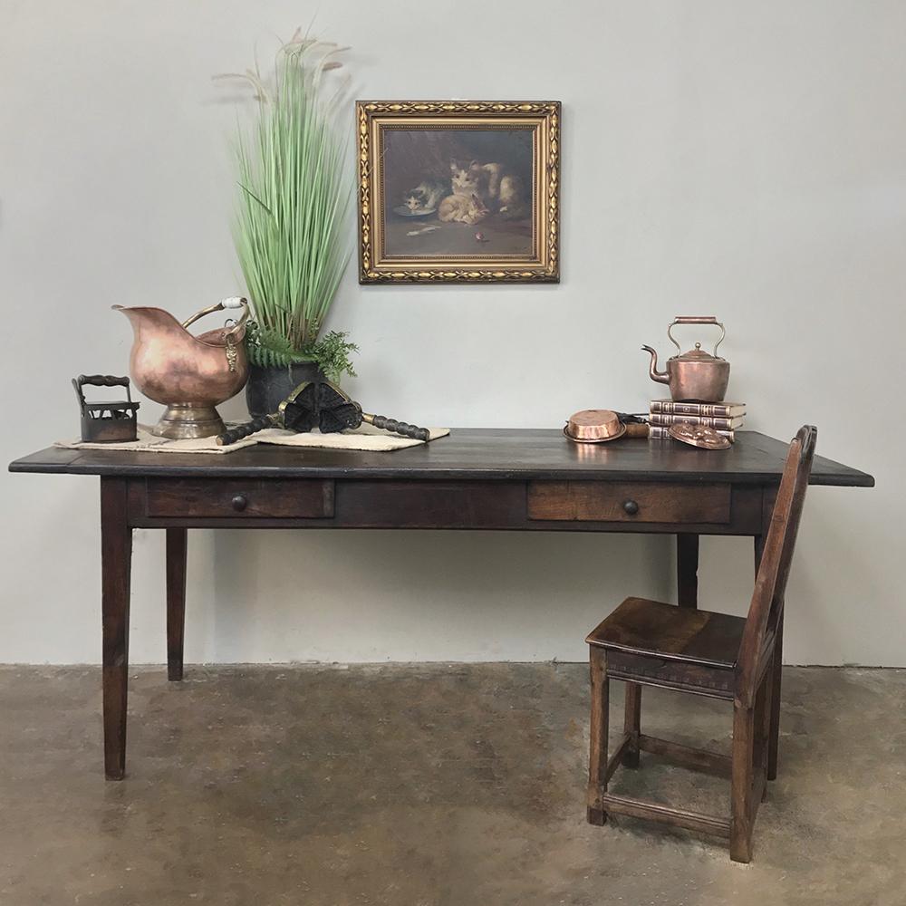 19th century rustic country French oak farm table, desk was hand-hewn from solid planks of old-growth oak to last for generations, and makes the perfect choice for the casual decor. Taller than most antique tables, its better suited for today's 21st