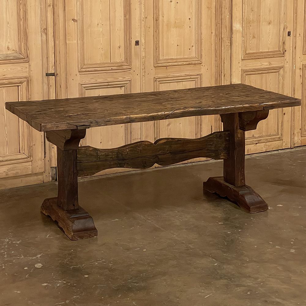 19th century Rustic farm trestle table is perfect for adding rustic charm to your dining experience! Hand-crafted from thick, solid planks of old-growth oak, it was literally designed to last for centuries. The plank top is affixed to a sturdy