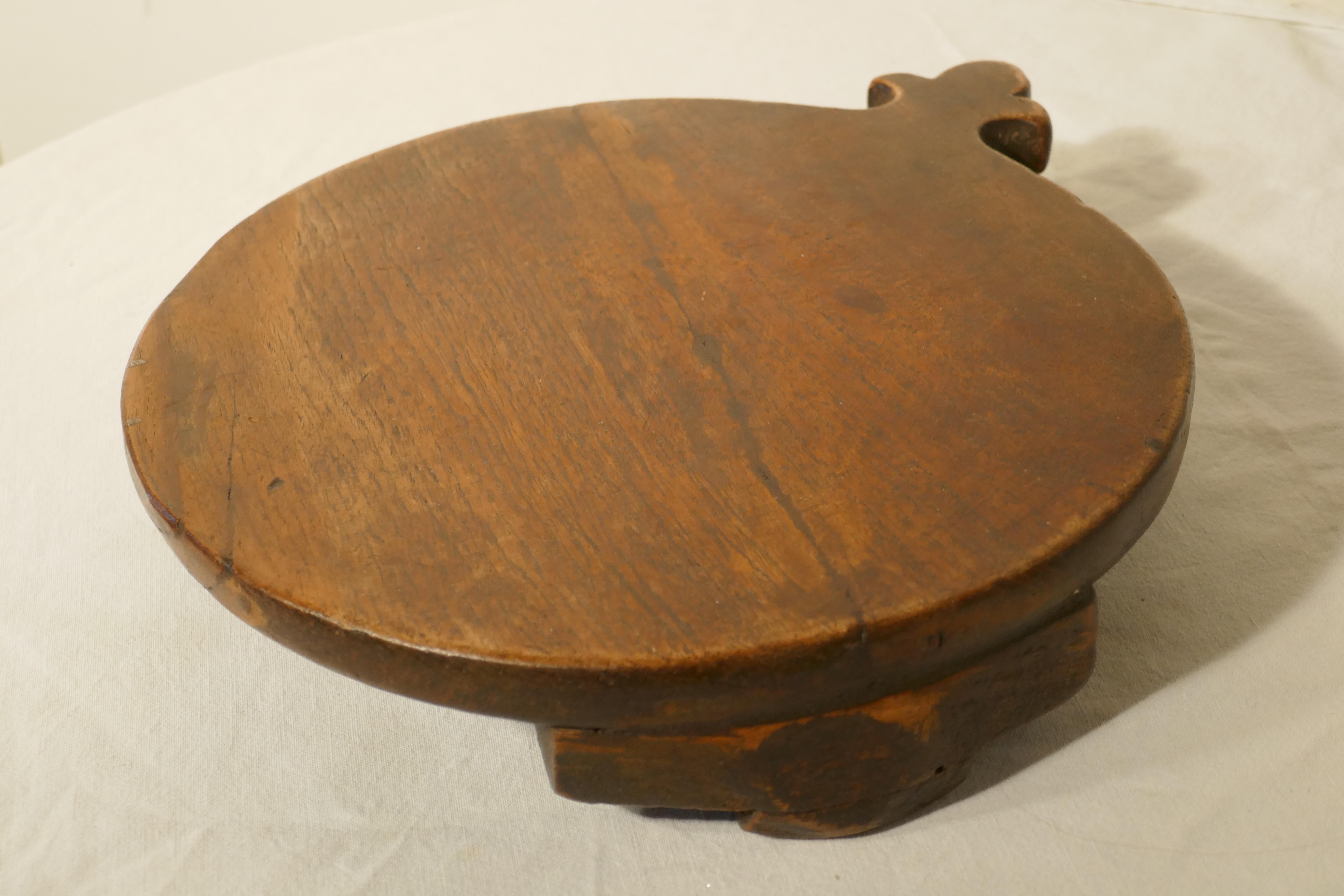 19th Century Rustic French Elm Cheese Board

A lovely tactile piece, this round French cheese board stands on small feet with a handle to one side, it is made in solid elm
The board is 2” high and 12” in diameter
PG66