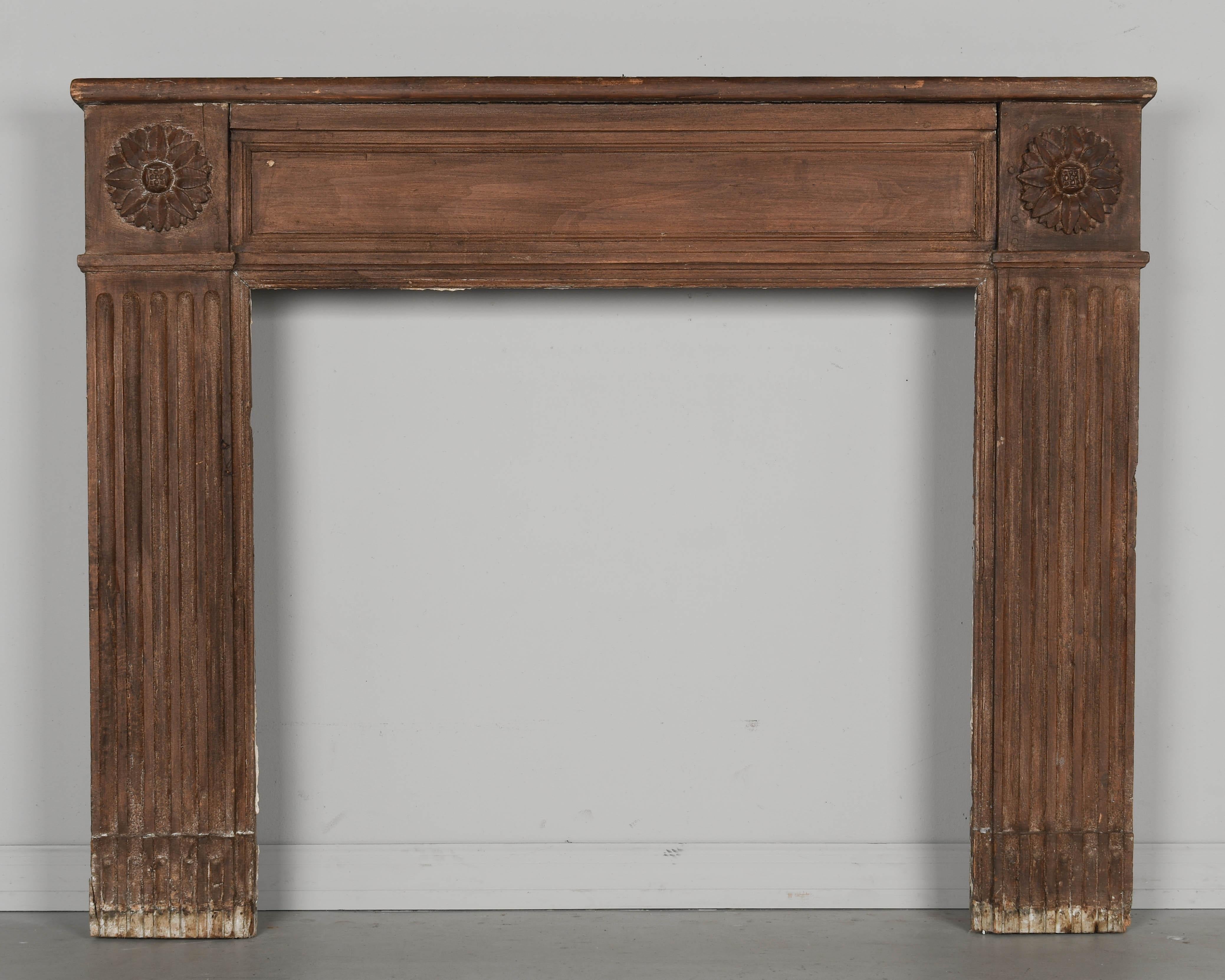 A late 19th century rustic French Country fireplace mantel made of pine with carved flower medallions in the corners. Good condition with some wear. Pegged construction. From Central France. Circa 1870-1890
Overall dimensions: 51.5