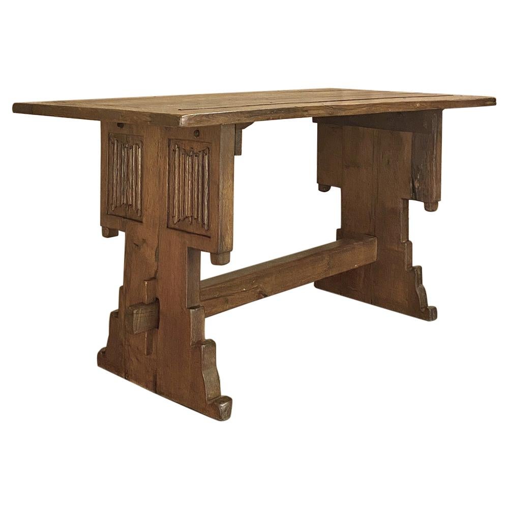 19th century rustic Gothic oak trestle table is a handsome piece, handcrafted from seasoned old-growth oak by talented rural artisans using time-honored mortise and tenon joinery. Ideal as a small dining table, as a library table, or as a computer