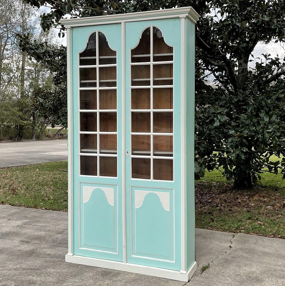 19th Century rustic Louis XIV painted bookcase features elegant, tailored lines enhanced by the sky blue and white painted finish. An exceptionally shallow design, it will fit where most bookcases would encroach upon the floor space. Multiple