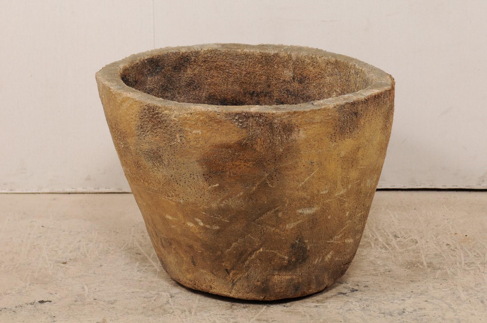 A 19th century palm root storage pot from Guatemala. This antique round-shaped palm root pot has a pure, clean form which plays nicely with it's more fiberous and rugged texture. This piece would have been used as a large storage pot, with ample