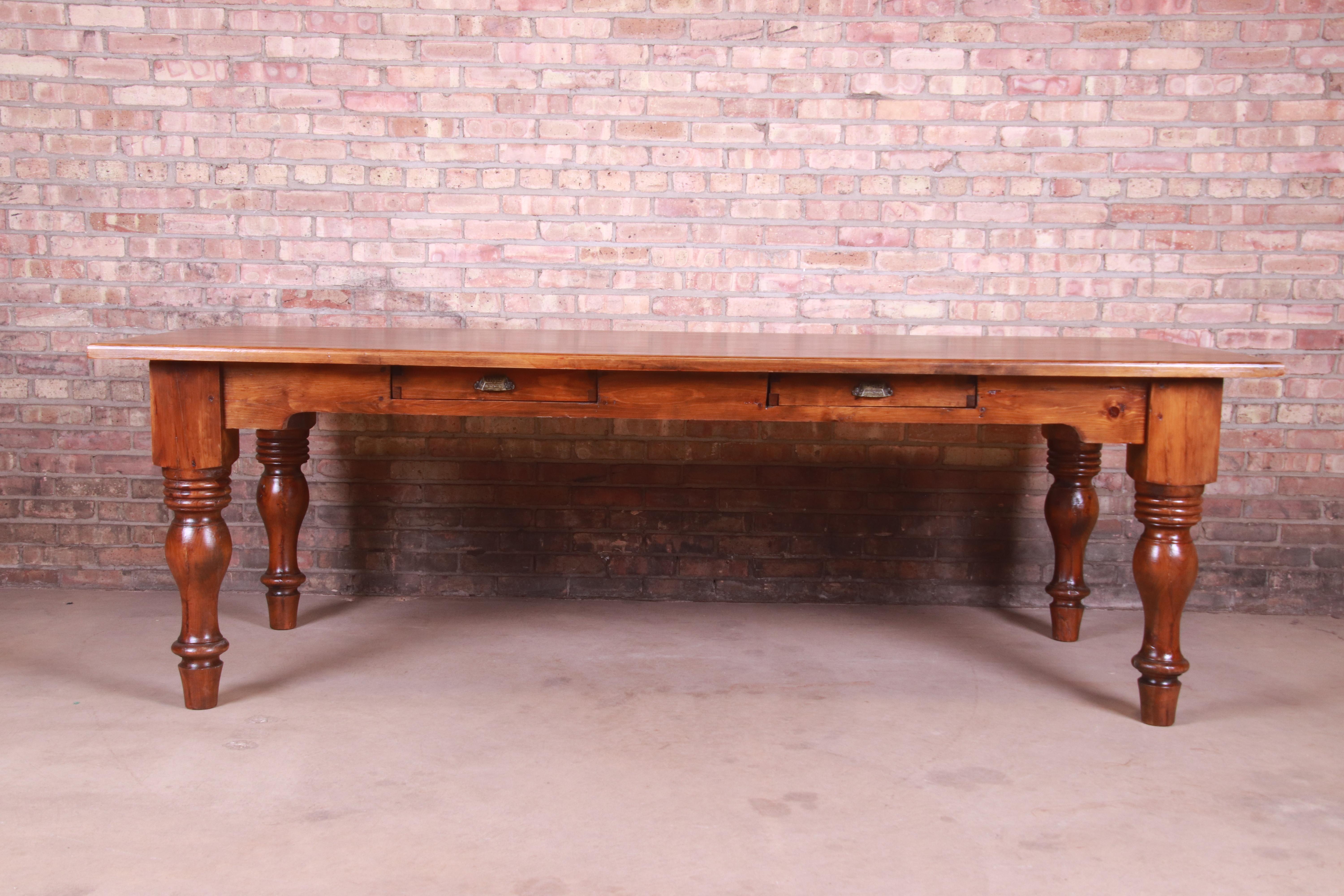 A gorgeous antique solid pine harvest dining table with two drawers

USA, 19th Century

Solid pine with turned legs, two drawers, and original brass hardware.

Measures: 96