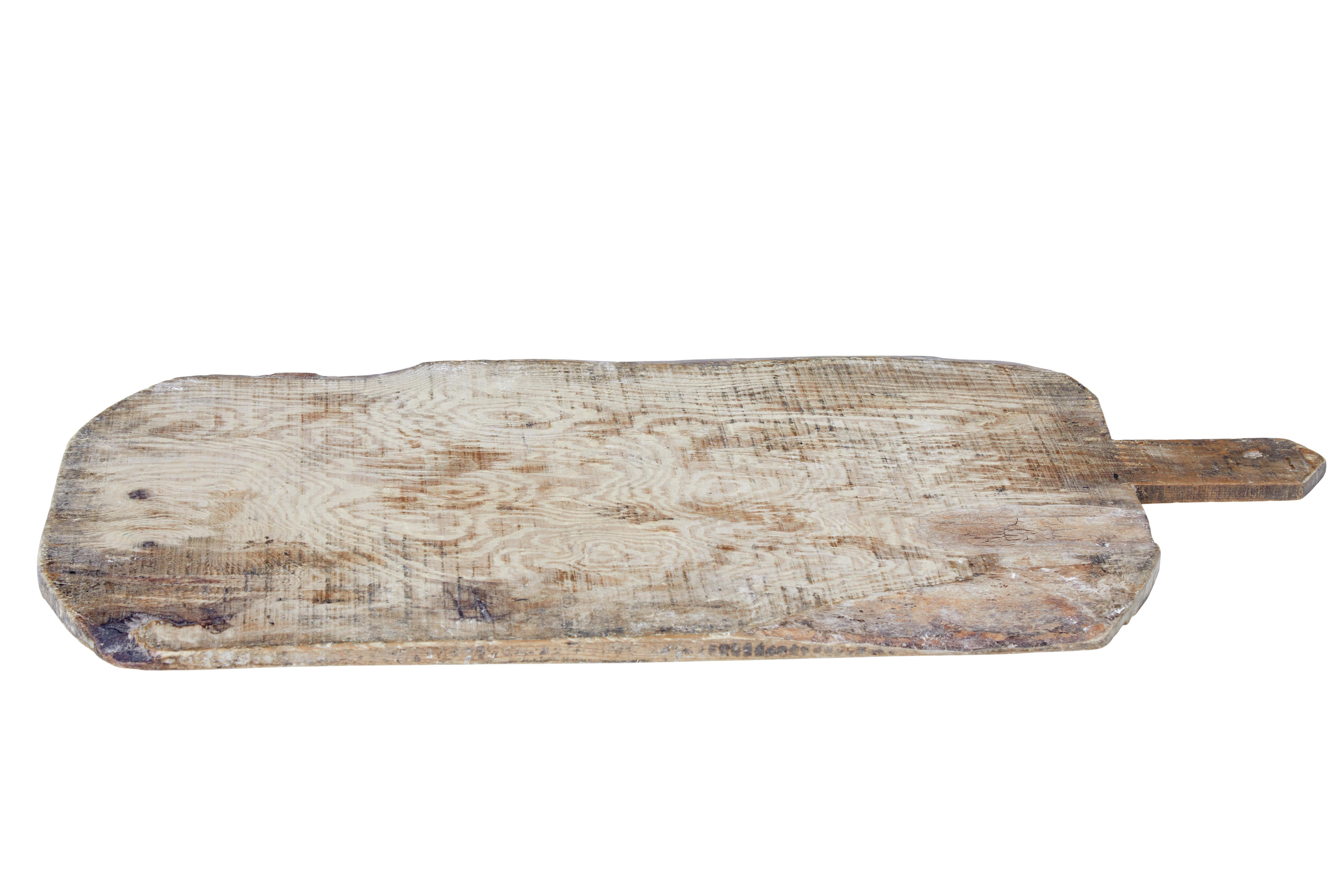 19th century rustic Scandinavian bread board circa 1890.

Rustic piece of Swedish kitchen ware. Made from 1 solid piece of pine including the handle. Handle has a hole in it so it could be hung up.

Ideal decorative item, or for using as a