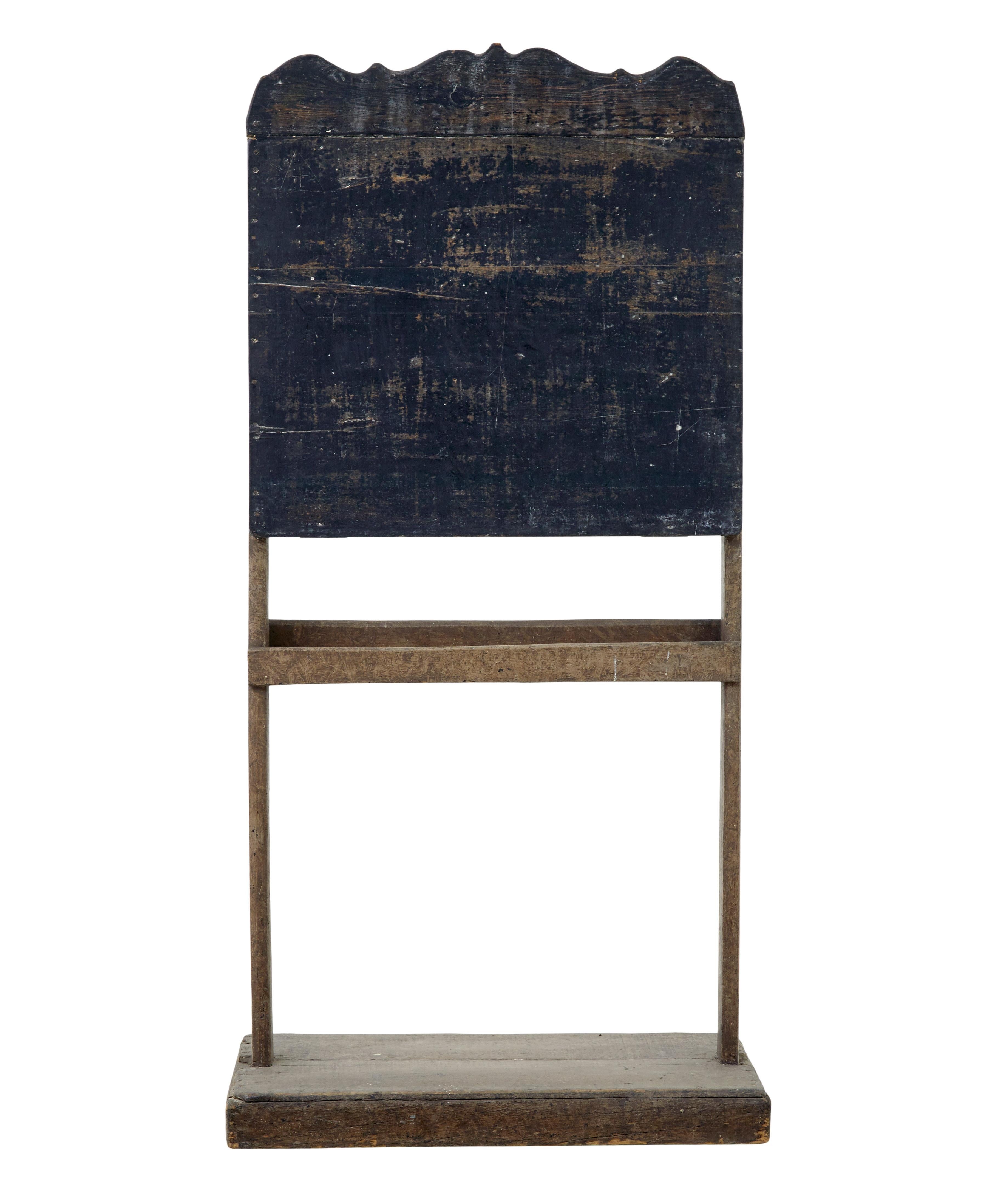 19th century rustic Swedish children's blackboard circa 1880.

Blackboard writing surface on stand with chalk storage well.  Ideal for use in retail for signage or for a quirky feature around the home.

Some loss to paintwork, marks to woodwork.