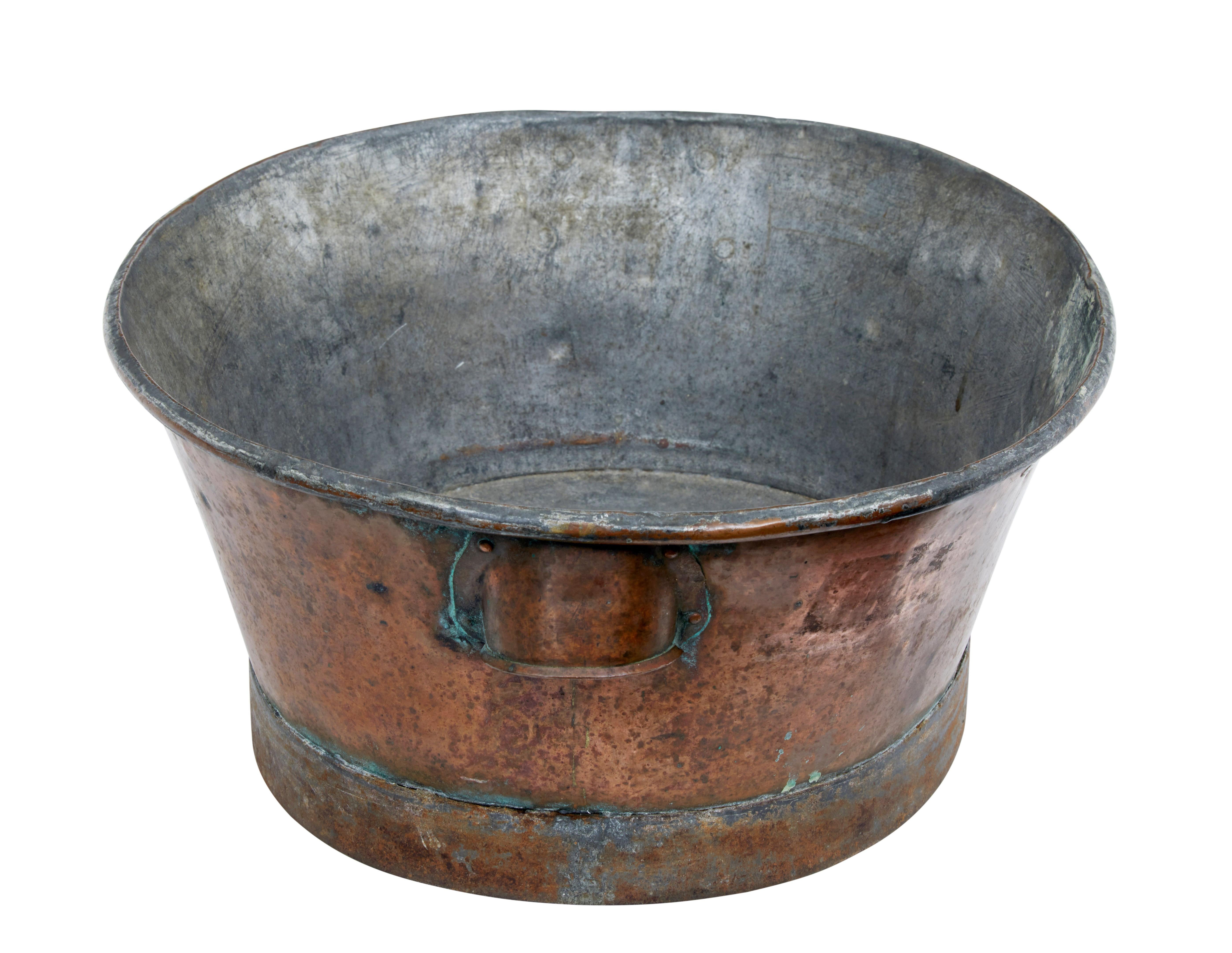 19th century copper vessel, circa 1870.

Oval shaped with a cupped handle each end. Ideal for many uses today, such as a herb planter, small dog basket or for decorative use.

Obvious signs of use with surface marks.