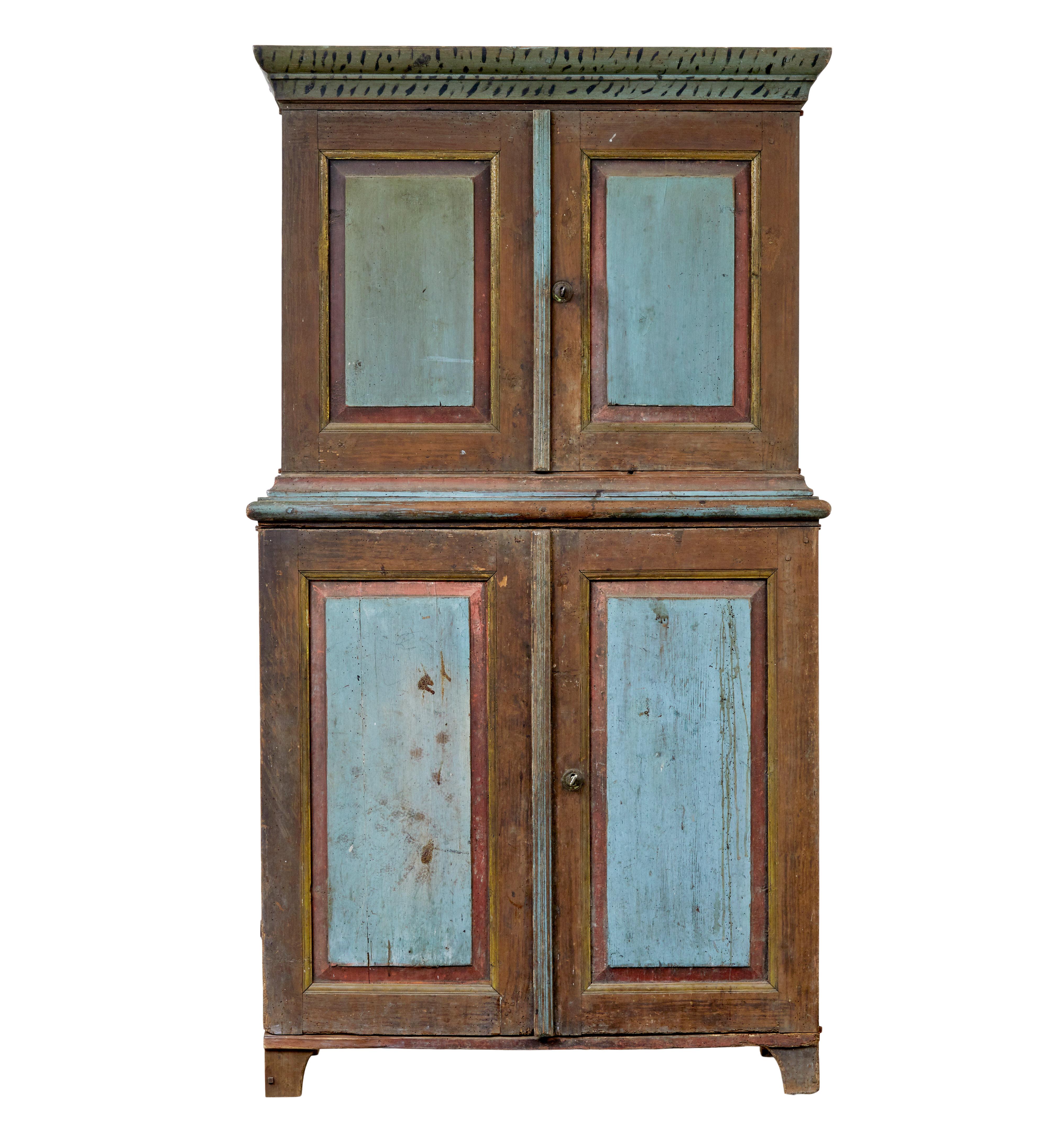 19th century rustic Swedish hand painted cupboard circa 1830.

We are pleased to offer this traditional hand painted piece of folk art from Scandinavia.

Comprising of 2 sections.  Top part with painted cornice and a double door cupboard with
