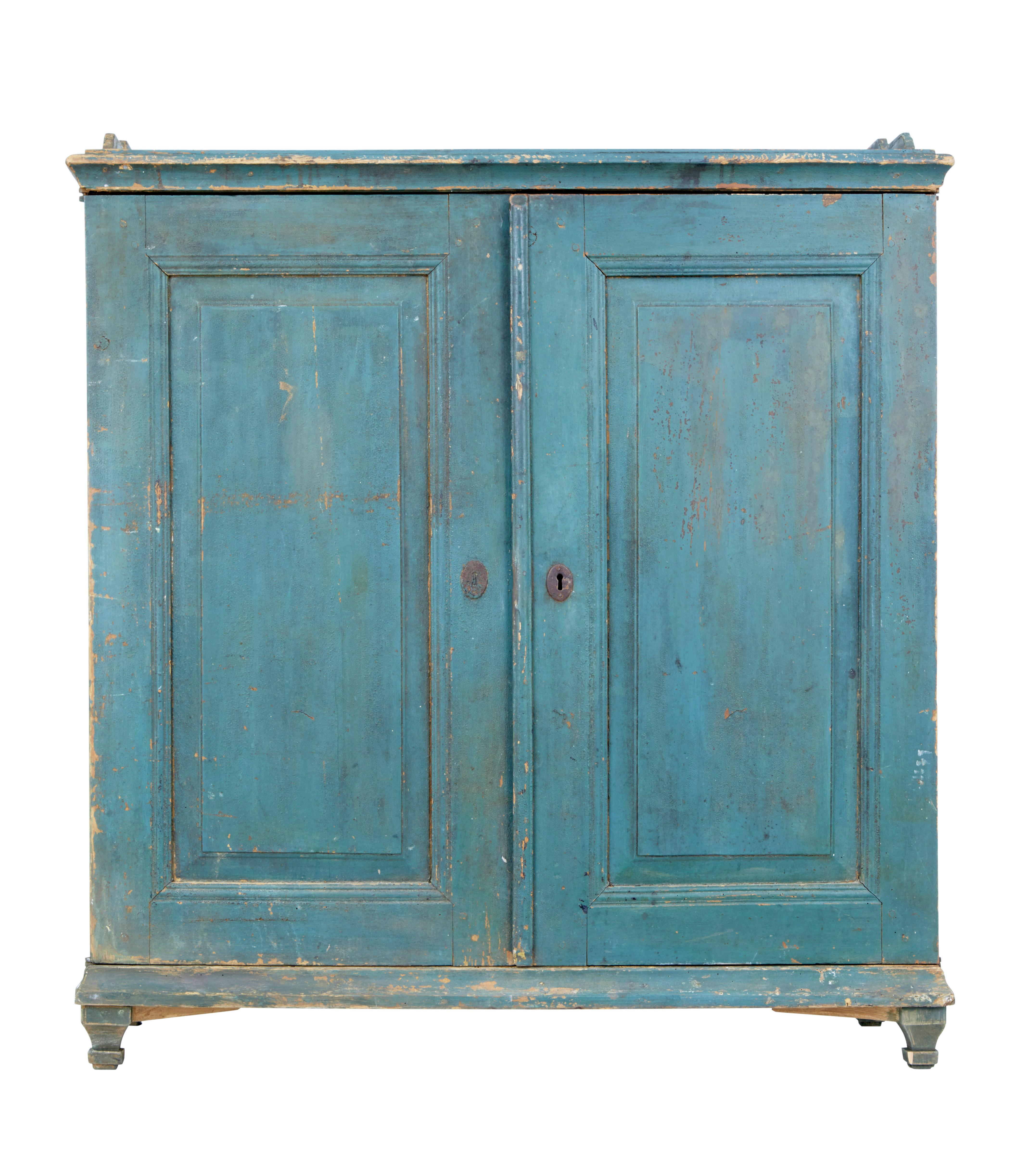 Delightful traditional Swedish cupboard, circa 1860.

Presented in original 19th century paint which has taken on a desirable color from natural fading.

Top surface with shaped gallery. Double door front with fielded panels opens to reveal a