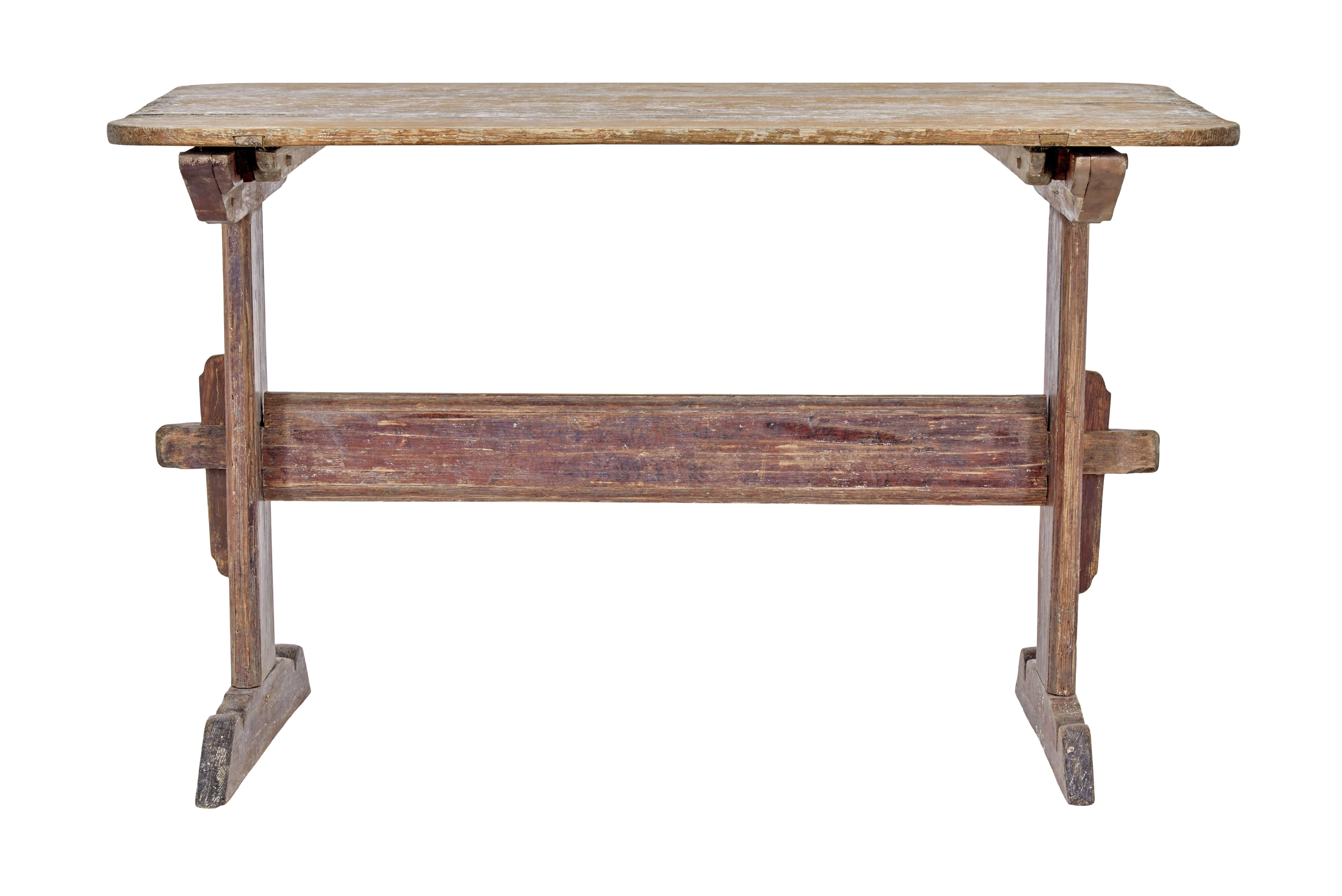 19th century rustic swedish painted trestle table circa 1840.

Here we have a traditional swedish table with traces of the original paint.

Light orange painted top with evidence that it may have been used for baking, supported red painted trestle