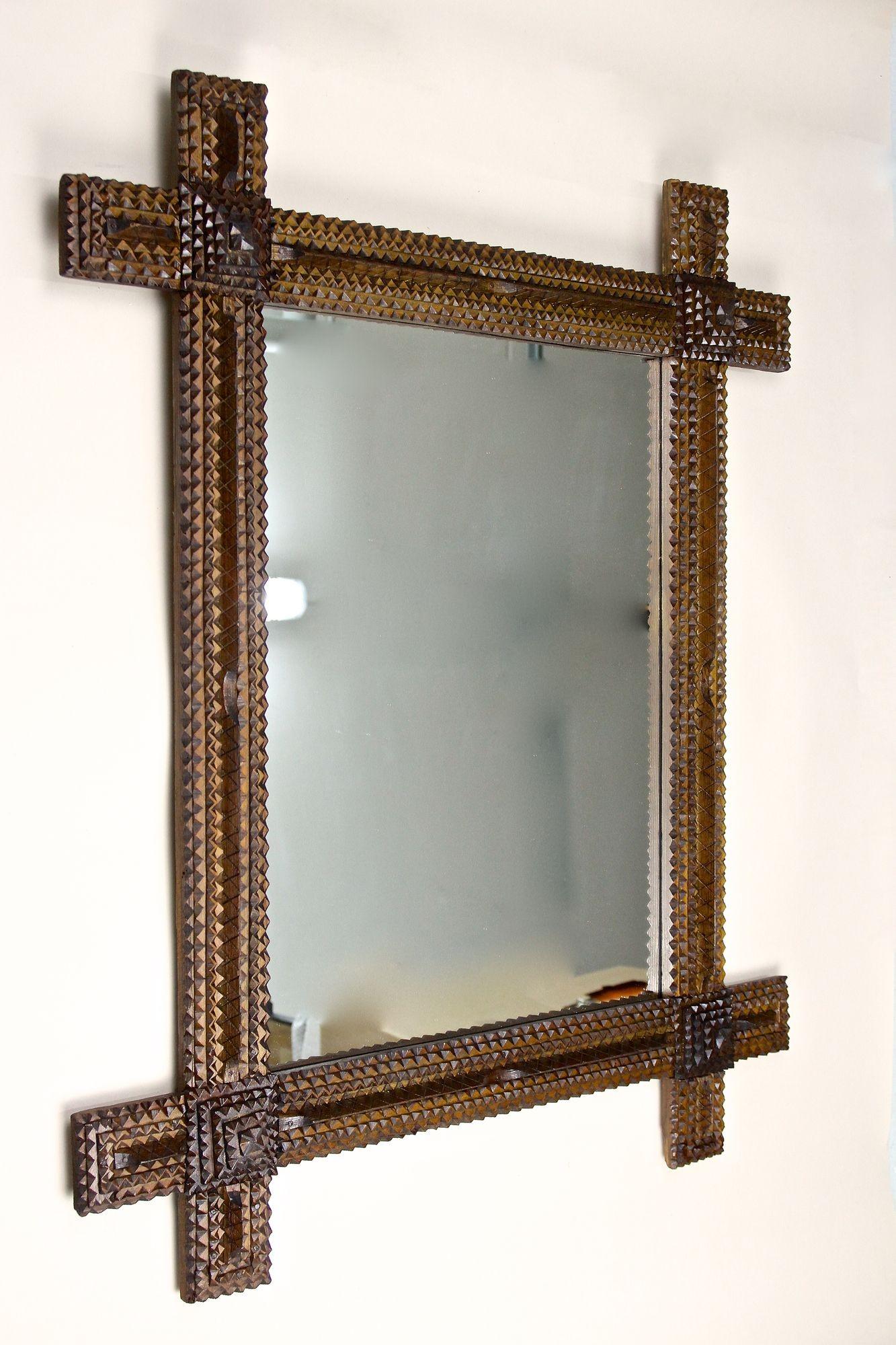 Extraordinary, large rustic Tramp Art wall mirror from the late 19th century around 1870 in Austria. This very special crafted, elaborately made rural wall mirror impresses with its amazing looking variety of different elements: pyramid styled