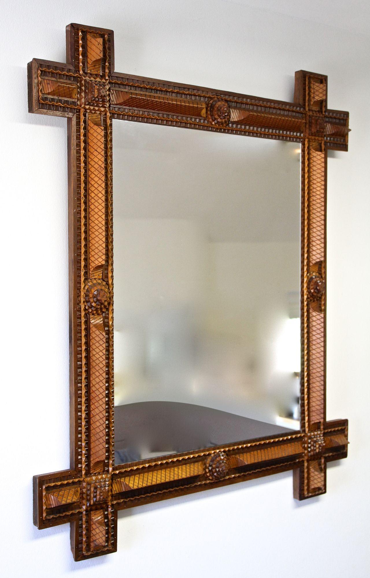 Very special crafted, extraordinary looking Tramp Art wall mirror from the late 19th century in Austria. This large, elaborately made rustic mirror from around 1890 impresses with its outstanding variety of different elements: chip carved square