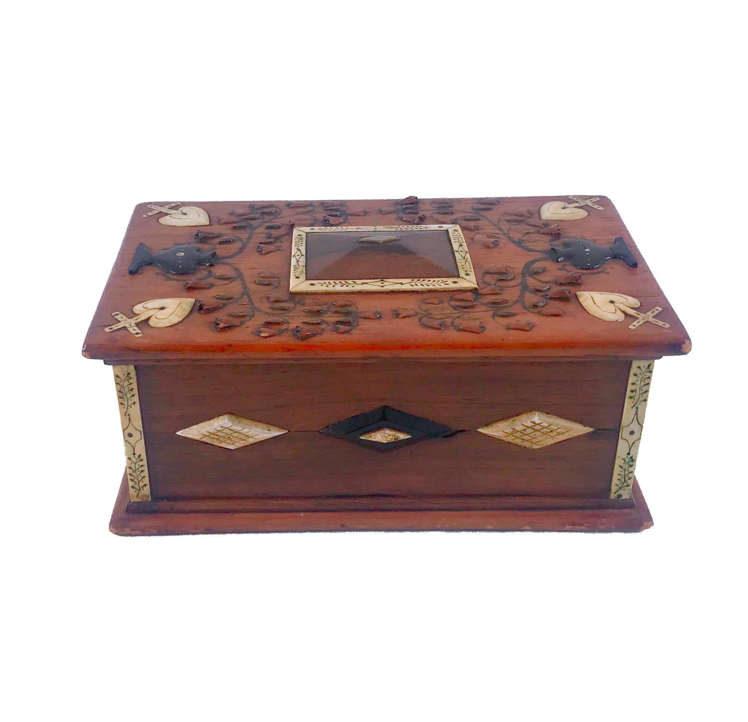 Intricately designed sailor made rosewood and pine lift top box
made from ebony, mother of pearl, ivory and whalebone.
The center of the lid having a pyramid top with a mother of pearl diamond and surrounded by whale ivory panels with the rest of