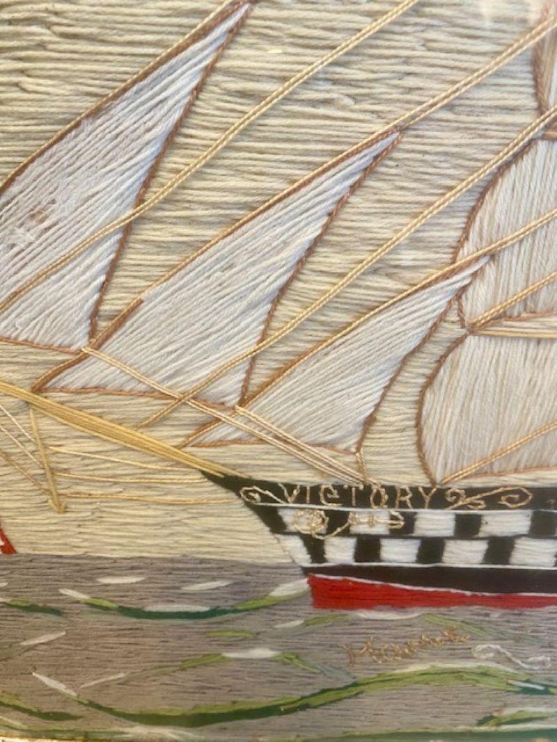 19th Century Sailor's Woolie of a British Brigantine, signed by the sailor-maker, circa 1850, with a larboard side view of a British Brigantine named VICTORY, flying the British ensign off the Main gaff and pennants at both mastheads, sailing on a