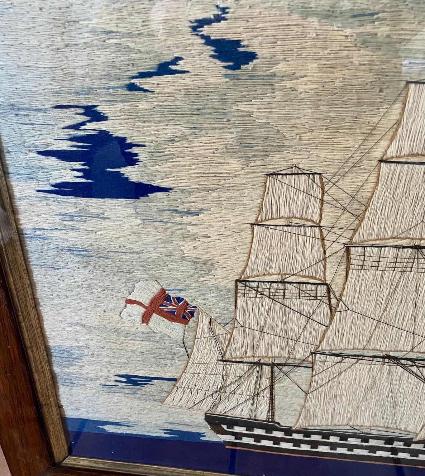 19th century Sailor's Woolie of a double decker ship of the line, circa 1870, a sailor's hand embroidered woolen yarn panel depicting a British naval ship with all sails set, flying the English St. Georges Cross and British White Ensign, under a