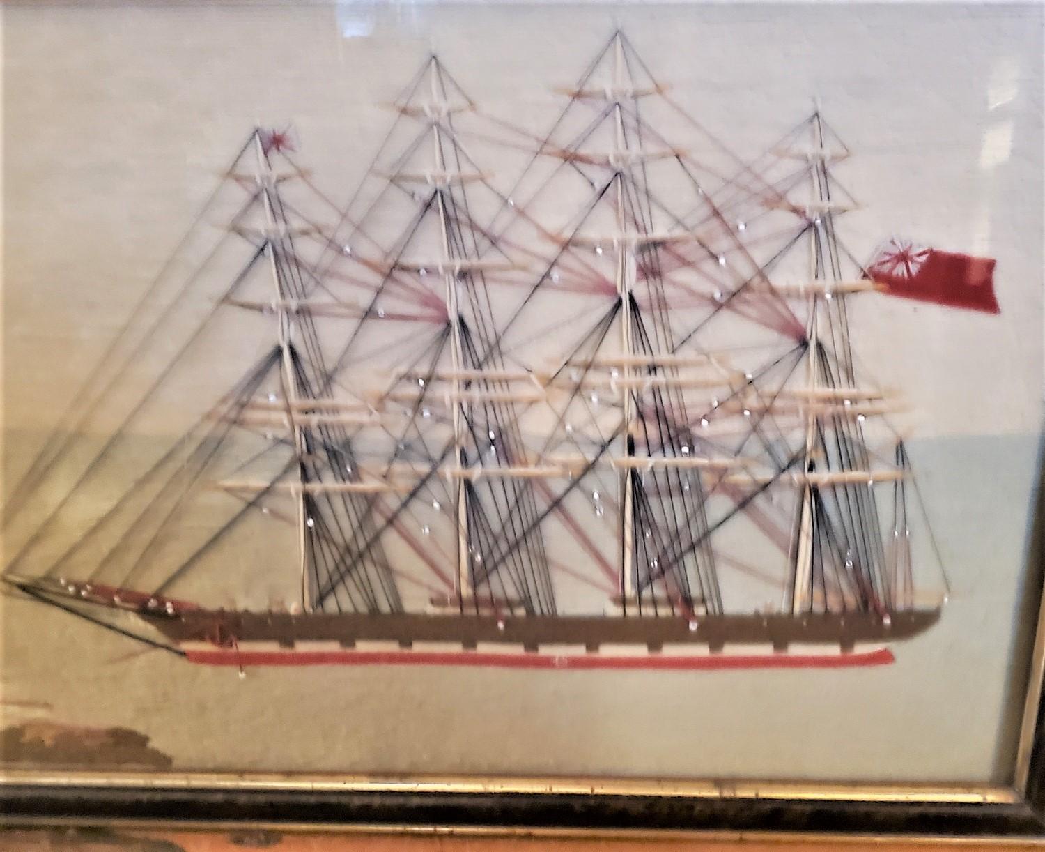 19th Century Sailor's Woolie port-side view of a four masted ship at anchor, circa 1880 - one of a matched pair - this one a port-side view of a large four-masted ship at anchor off a coastline with lighthouse, with a small lugger sailing in the