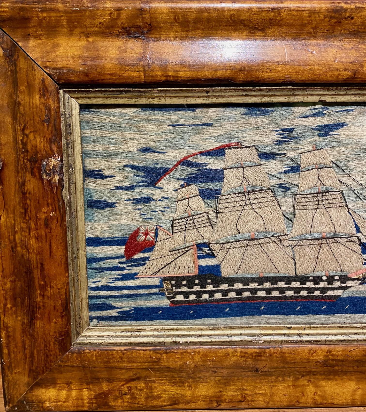 19th Century Sailor's Woolie with Double Decker Ship of the Line, circa 1860, a hand crafted sailor's woolwork picture with starboard side view of a double decker Ship of the Line  under full sail, flying the red ensign, under a brilliant, vivid