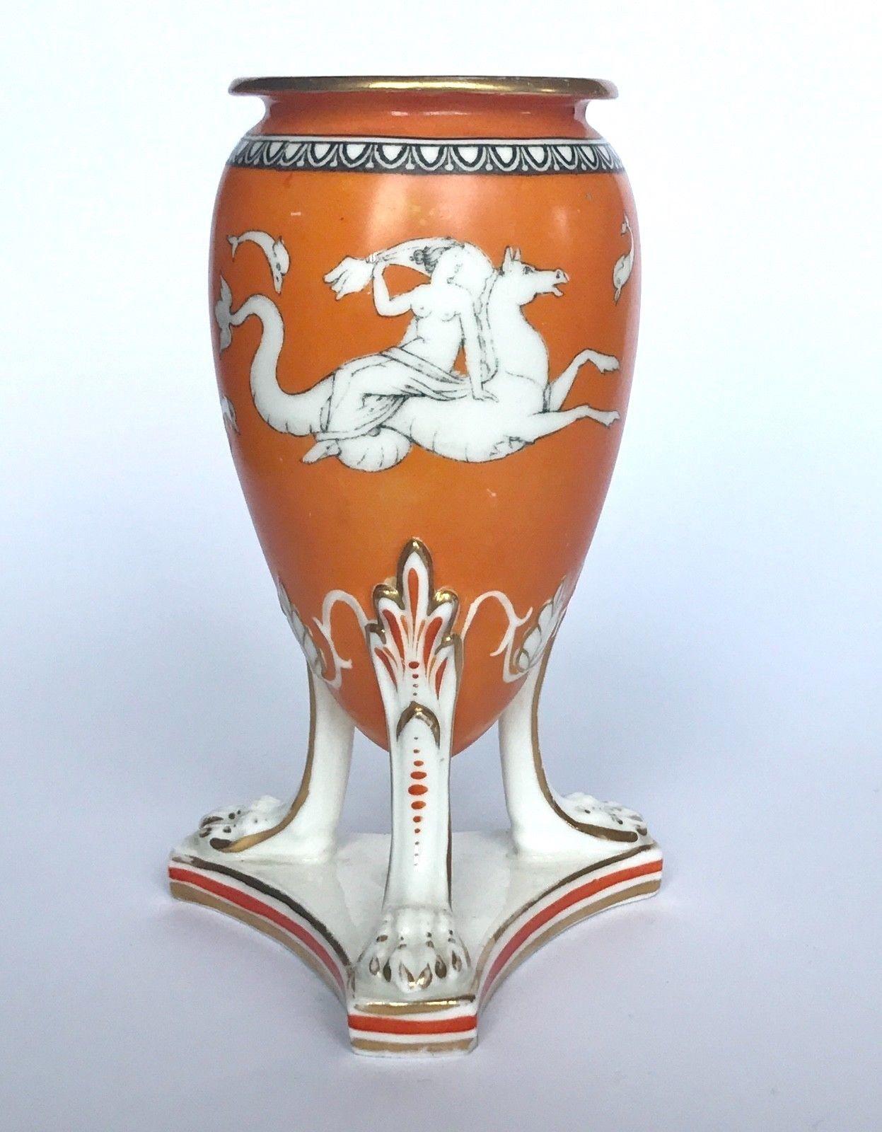 A Samuel Alcock porcelain neoclassical Revival Amphora vase, circa 1855, decorated with classical maidens riding hippocamp against an orange ground all supported on tri legged support.
The last  two images shows a group of other Alcock vases that