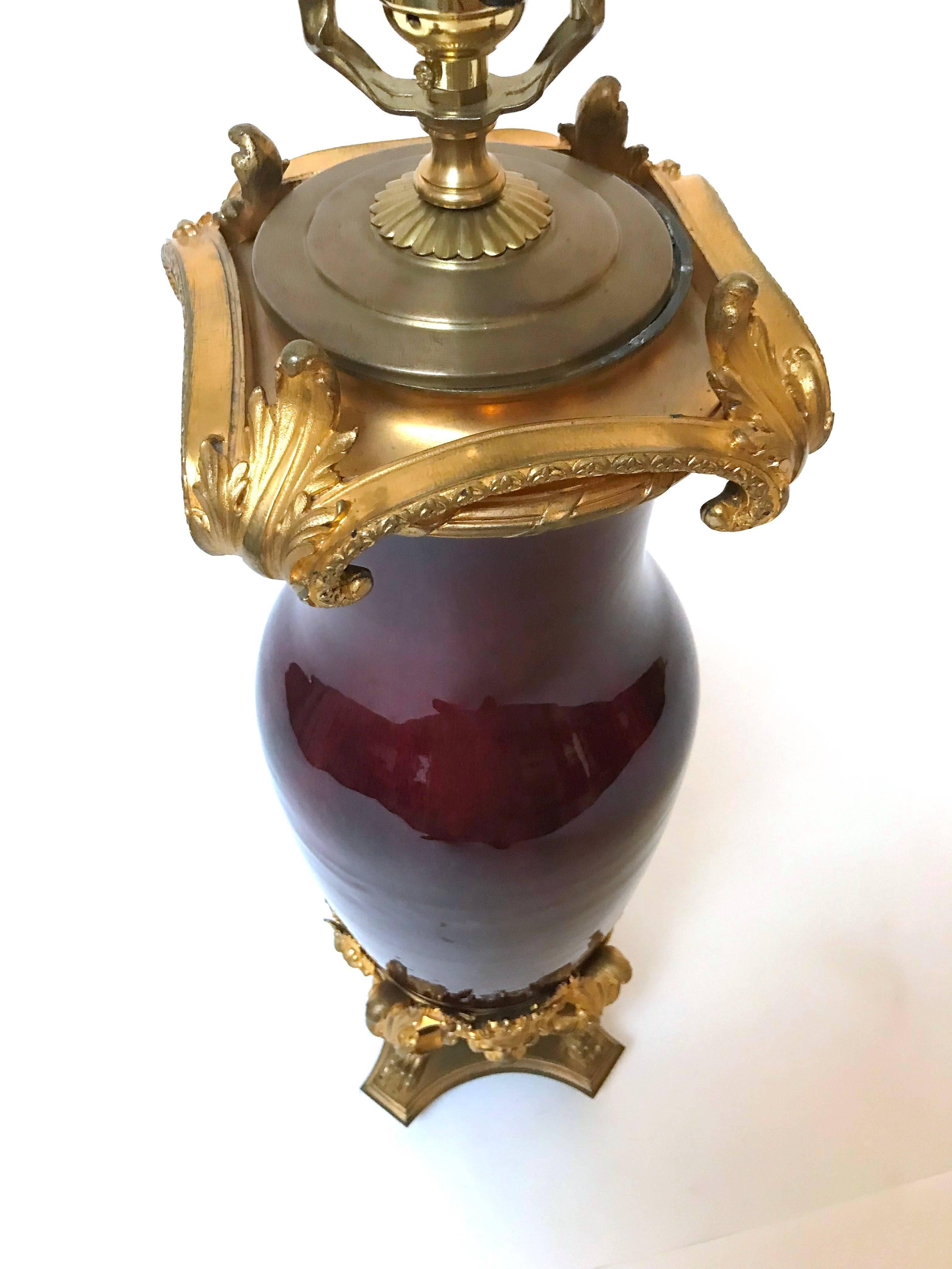A very nice ormolu-mounted Sang de Boeuf vase with pawed feet, grotesque with ring, and acanthus scrolls, mounted in France in the 19th century, drilled for lamp in the 20th century.