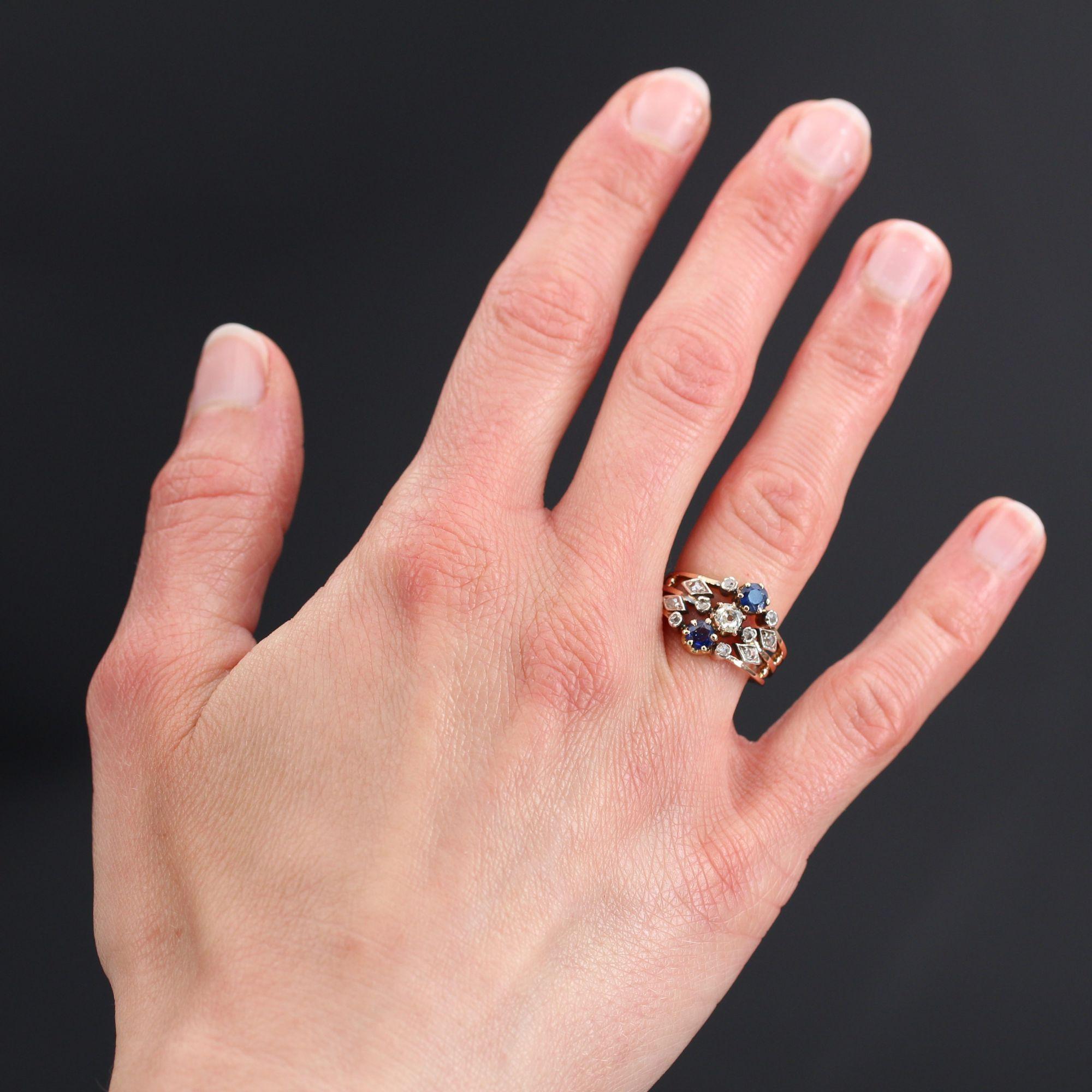 Ring in 18 karat rose gold.
Sublime and authentic antique ring, it is set on 3 openwork rings, two round sapphires and a cushion- cut diamond. On both sides, on each of the rings, is set a rose-cut diamond and two lozenge patterns set with rose-cut