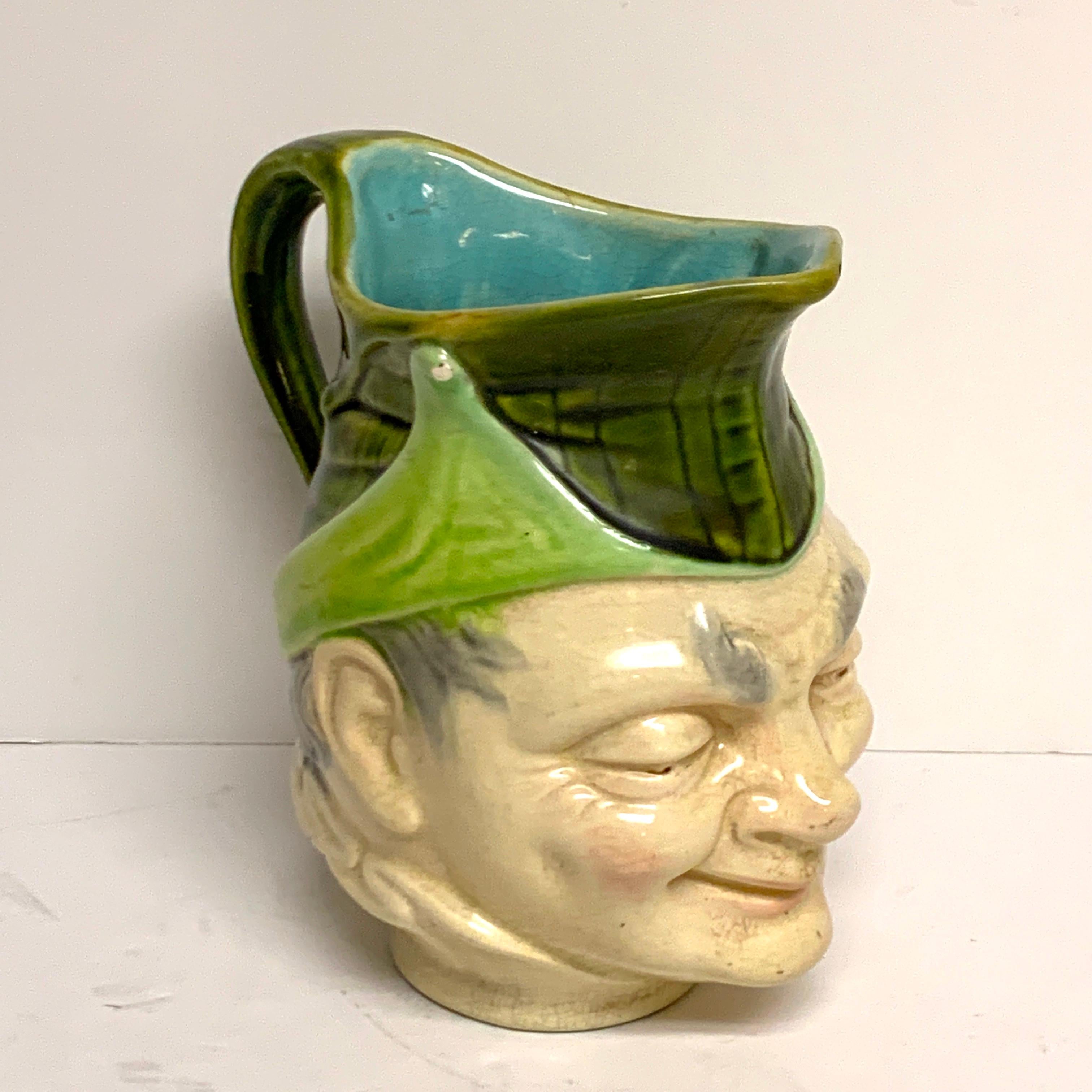 19th century Sarreguemines Majolica character pitcher, of typical form expressive man with hat, stamped Sarreguemines.