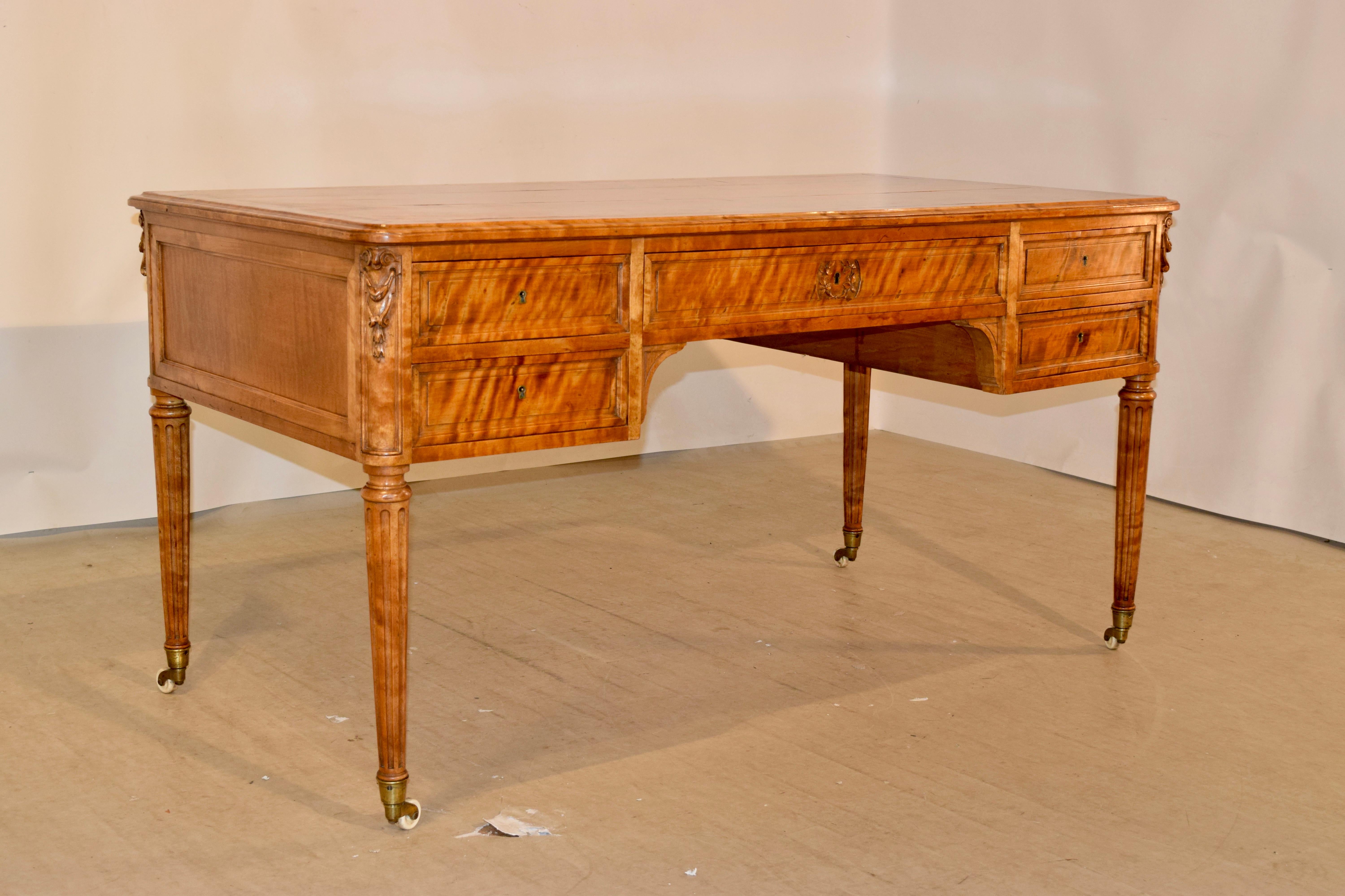 19th Century rare desk from England made from exquisite flame satin birch. The entire desk appears to be alive with the graining of this fantastic wood. The top is made of three boards and banded ends which are beveled as well. The desk itself has
