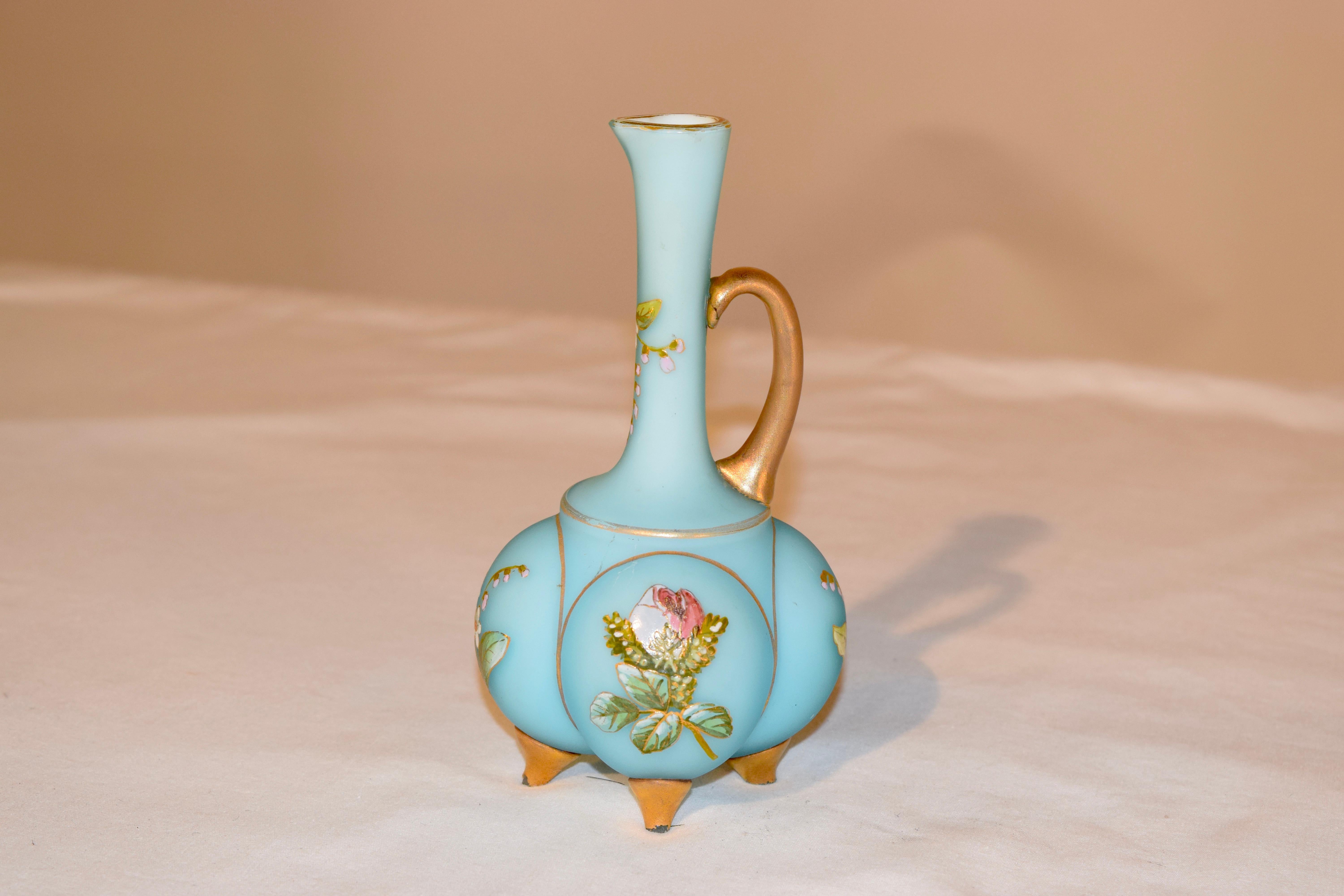 19th century satin glass cruet in a lovely blown form with applied glass handle and feet painted in gold. There are hand painted flowers on all sides.