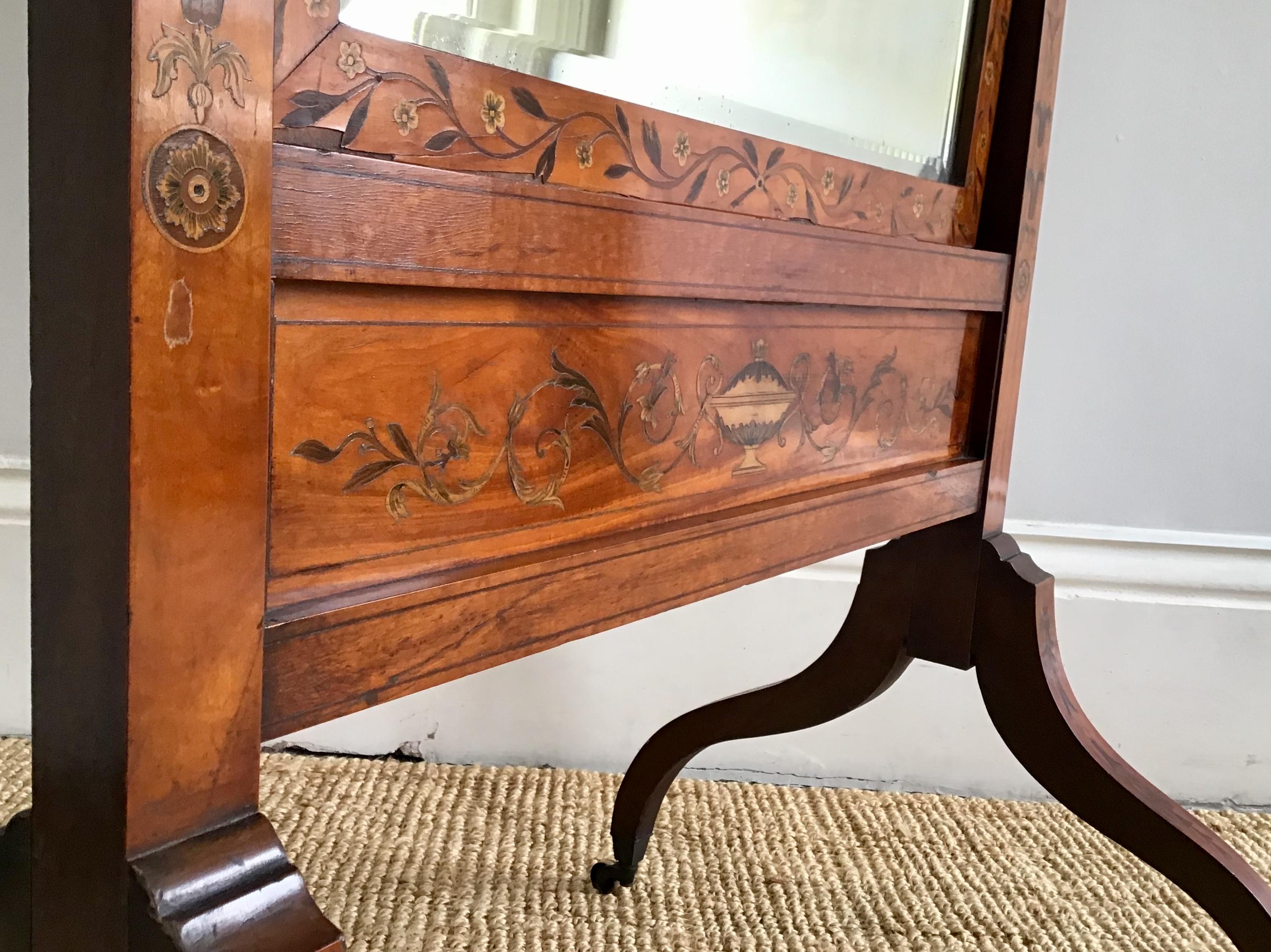 19th century satinwood with all over scroll and foliate marquetry in Harewood boxwood and purple heart with pen work highlights
The bevelled swing mirror adjustable for angle with original gilt metal knobs. The corners of swan neck form the four