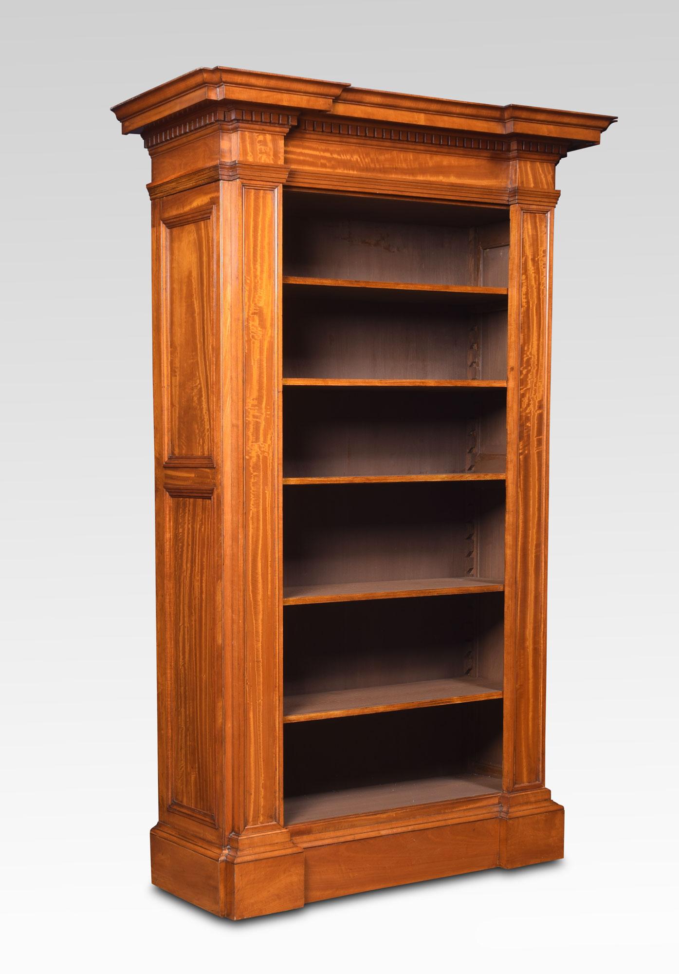 19th century satinwood open bookcase of architectural form, the stepped moulded cornice and dentil moulded frieze above five adjustable shelves flanked with fielded pilasters and panelled sides all raised up on a plinth base.
Dimensions:
Height 71