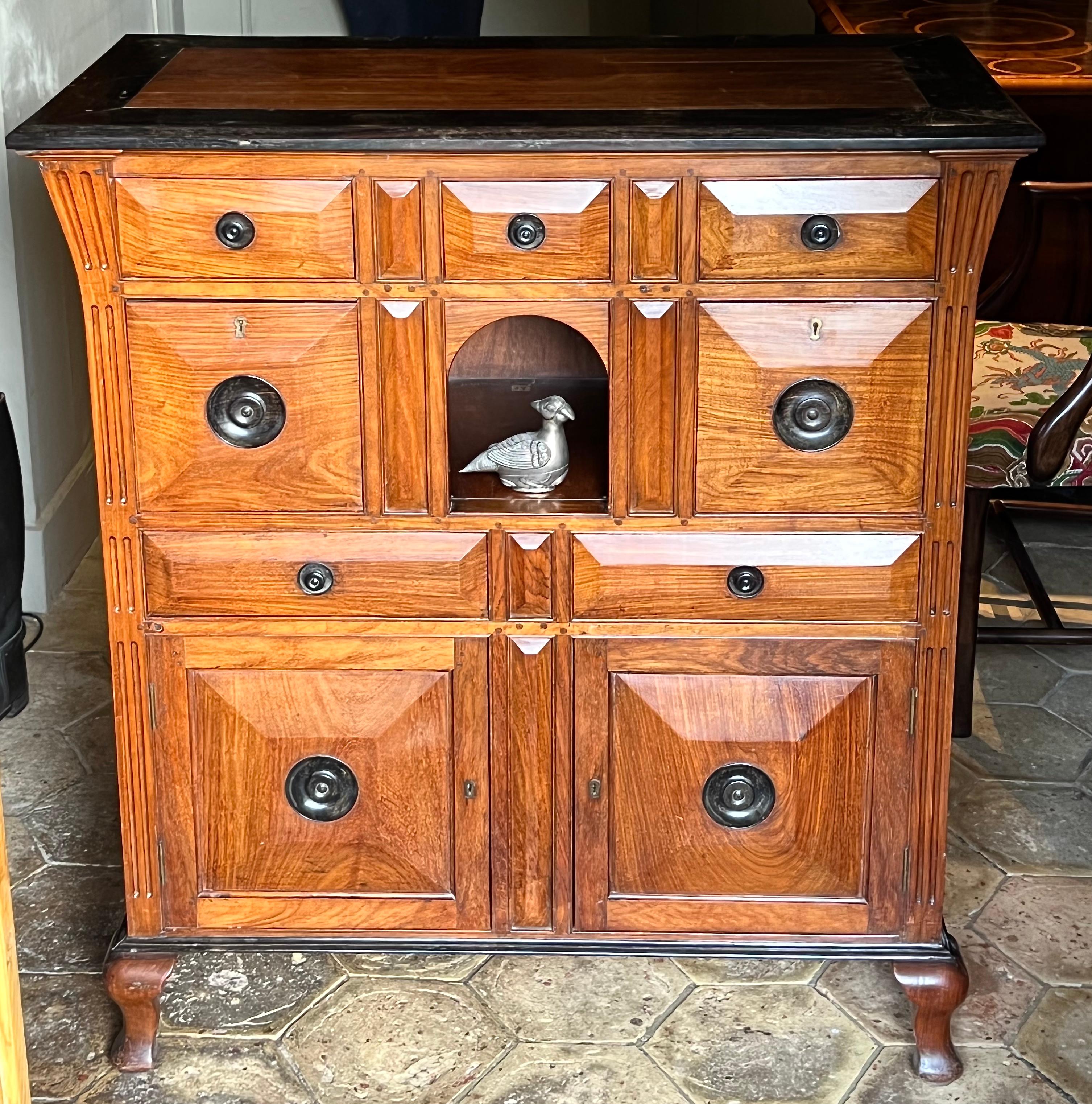 An unusual Colonial early-19th century solid satinwood-faced chest of drawers with cupboards.
Circa 1820.

The carcass is in solid rosewood and ebony. It features a broad ebony crossbanded mitred top.
All of very good rich colour, and in its