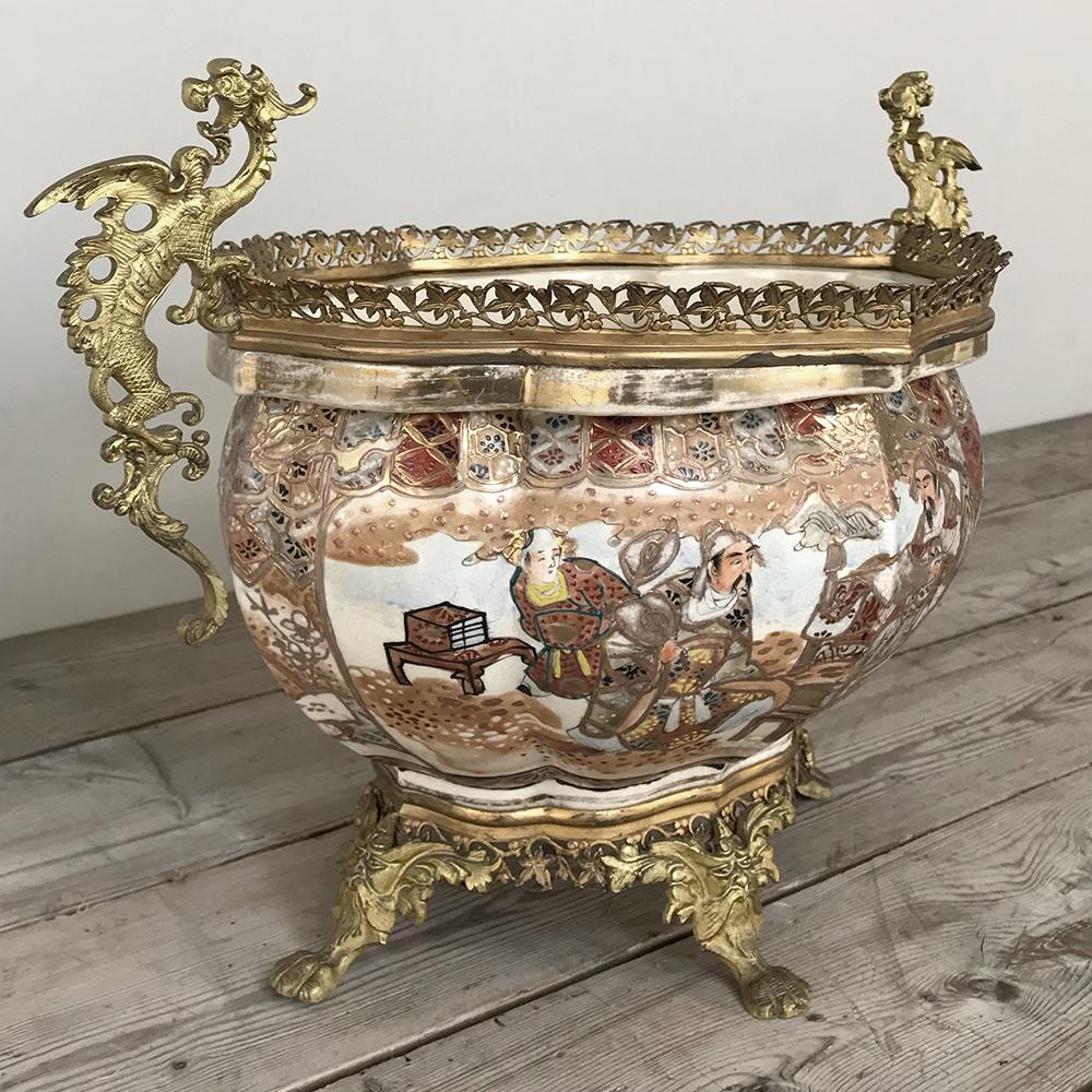 19th century satsuma gilt bronze-mounted jardinière is a stunning example of the collaboration between master Japanese ceramicists producing hand painted works of art that were then further embellished by bronze smiths in France for the lucrative