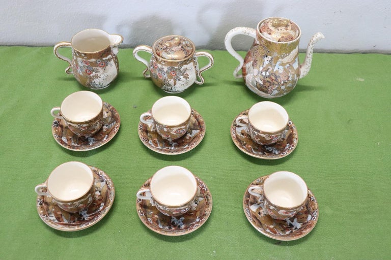 Beautiful hand painted and gold porcelain tea or coffee set Satsuma Japanese 15 pieces, 1880s. The service is complete to serve six people at the table includes: 1 teapot, 1 sugar bowl, 1 milk jug, six cups with saucers. Refined decoration with