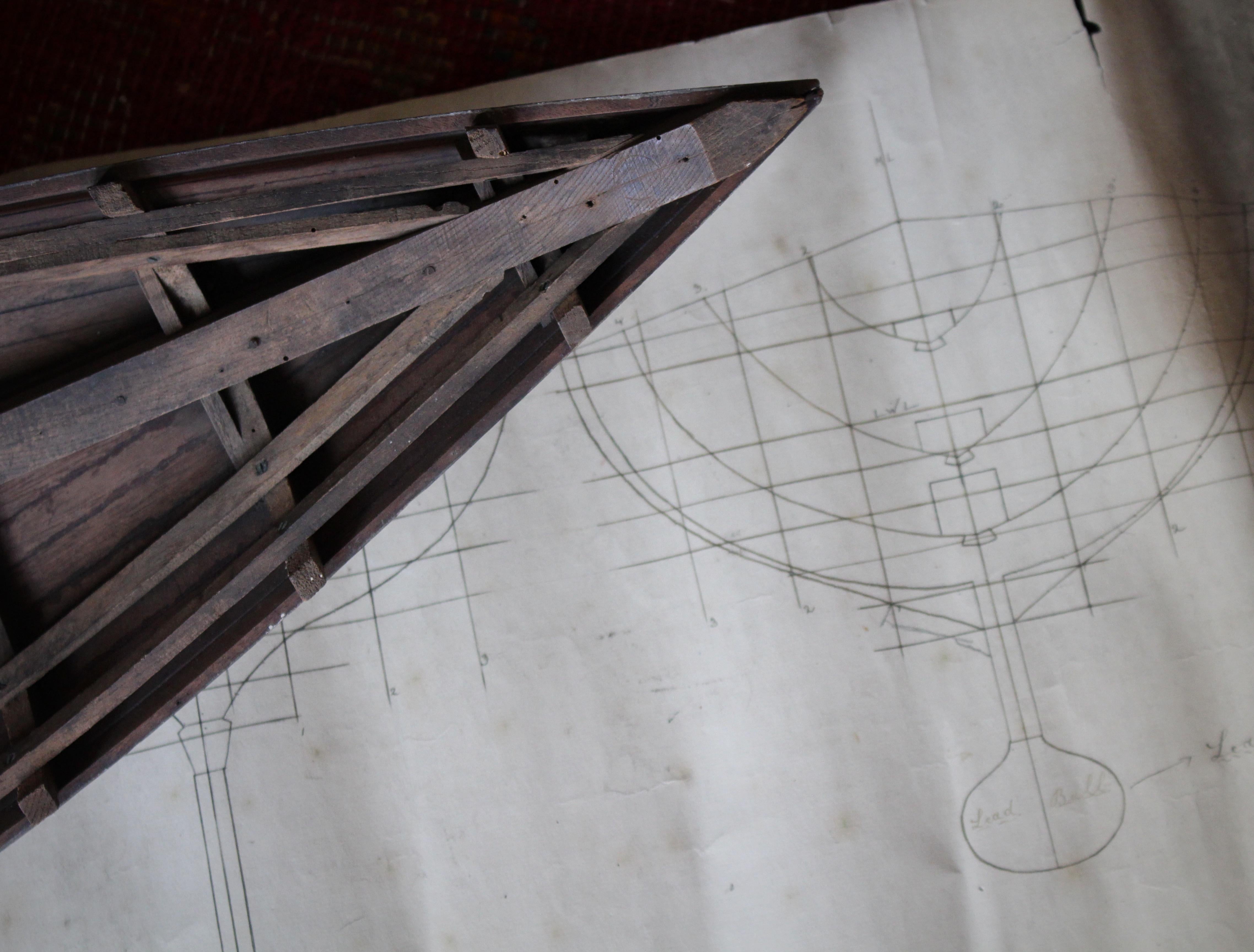 An interesting scale model hull of a vessel with its original line plans. The boat has its original painted exterior, and appears to be complete.

The plans are dated but unfortunately its illegible, a small section of the plans have been lost but