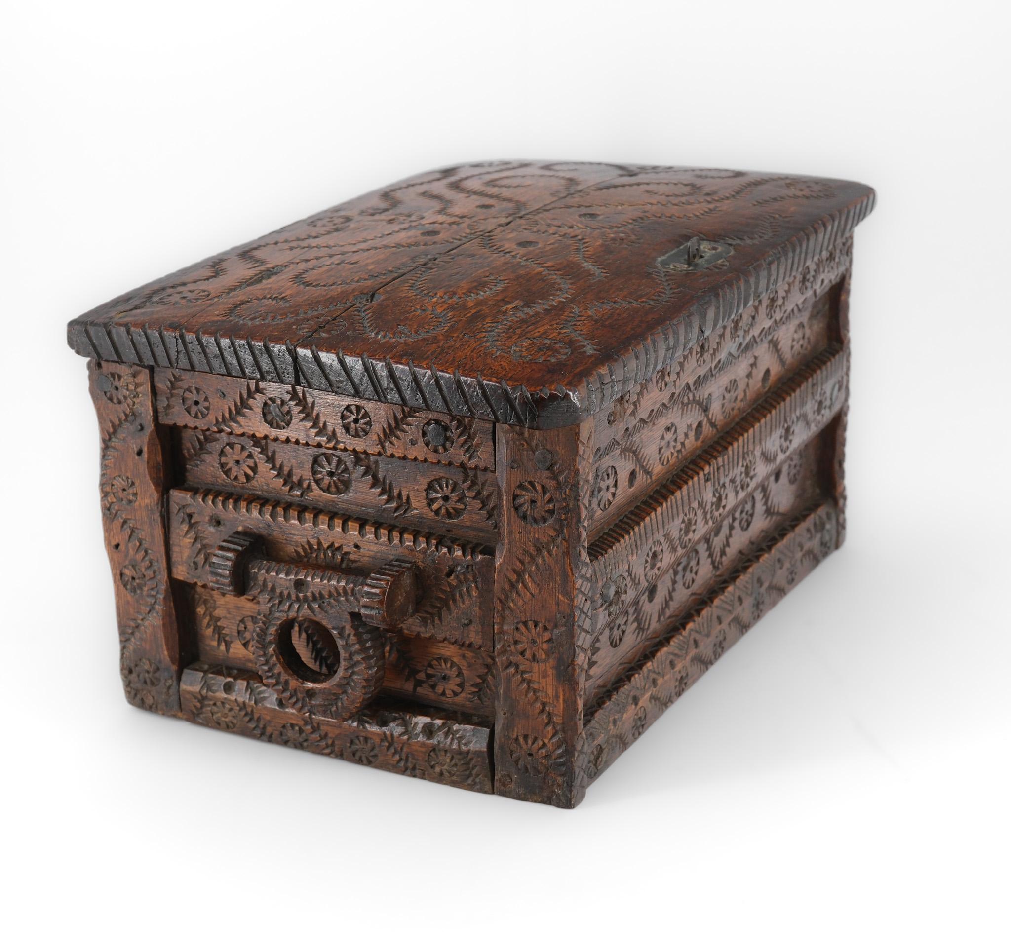 A lovely 19th century oak lidded-top table chest with hand carved leaf scrolls and roundel carvings, having swivel carrying handles to the sides.

The chest has a rustic charm and shows wonderful patina, especially to the top. The base is made of