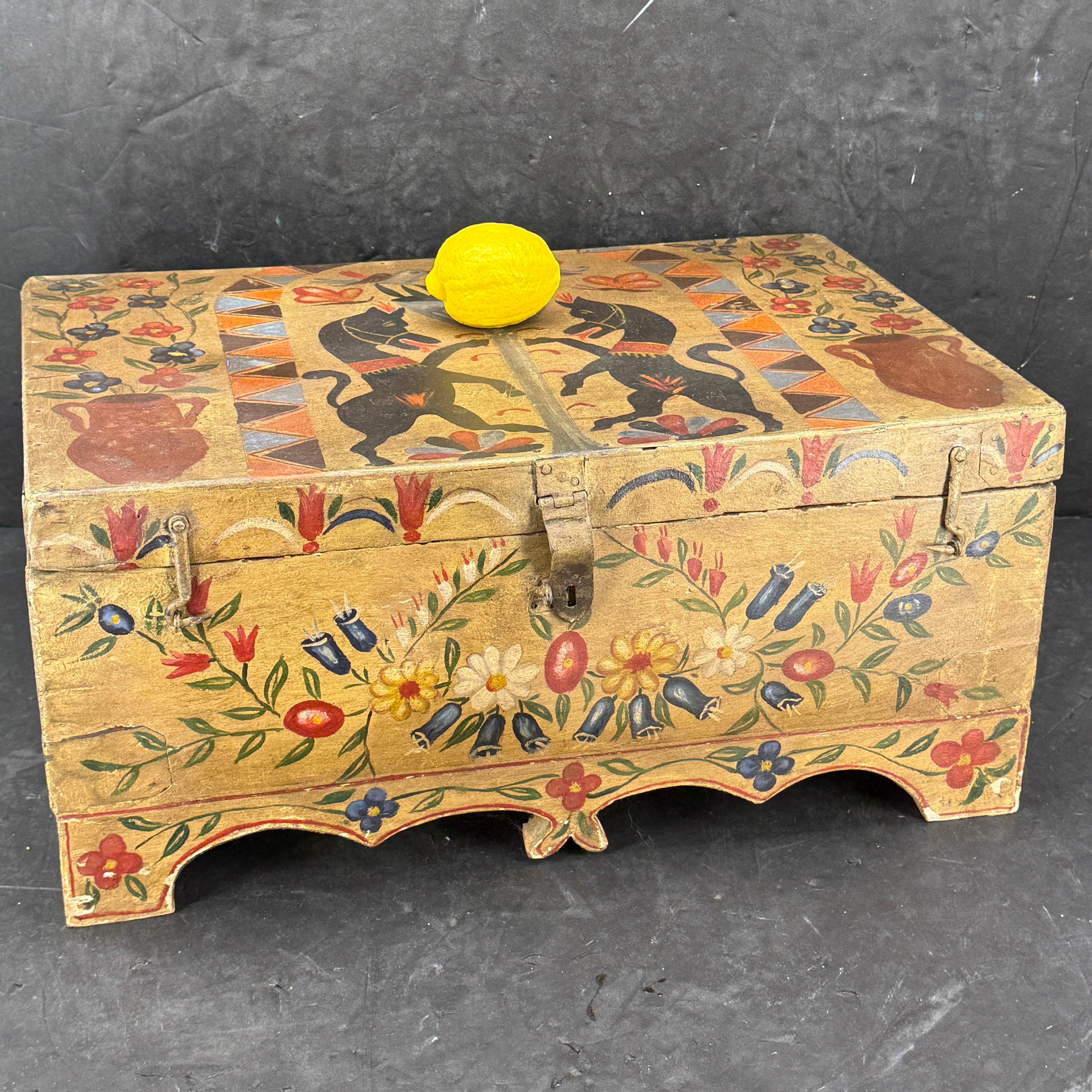Impressive hand-painted Folk Art box from the Late 19th Century. The box has been hand-painted in black, red, blues and green. There appears to be either twos horses or maybe unicorns on the lid and floral decoration throughout. Original paint and