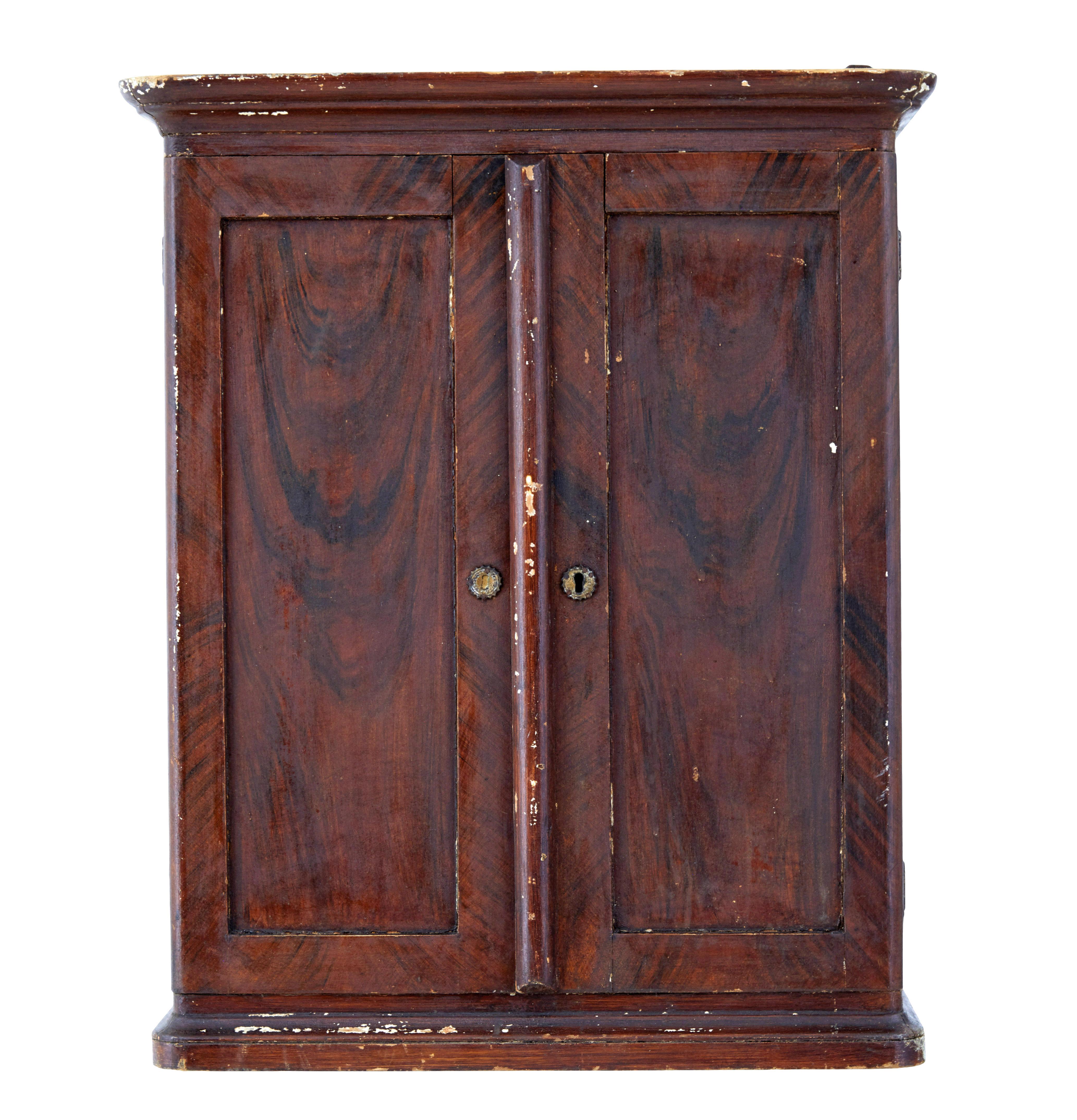 19th century Scandinavian painted wall cabinet circa 1870.

Large pine hand painted Swedish wall cabinet.  Made from pine and painted in a deep plum colour scheme with a hand painted effect over the top to simulate grain and tone.

Double doors open