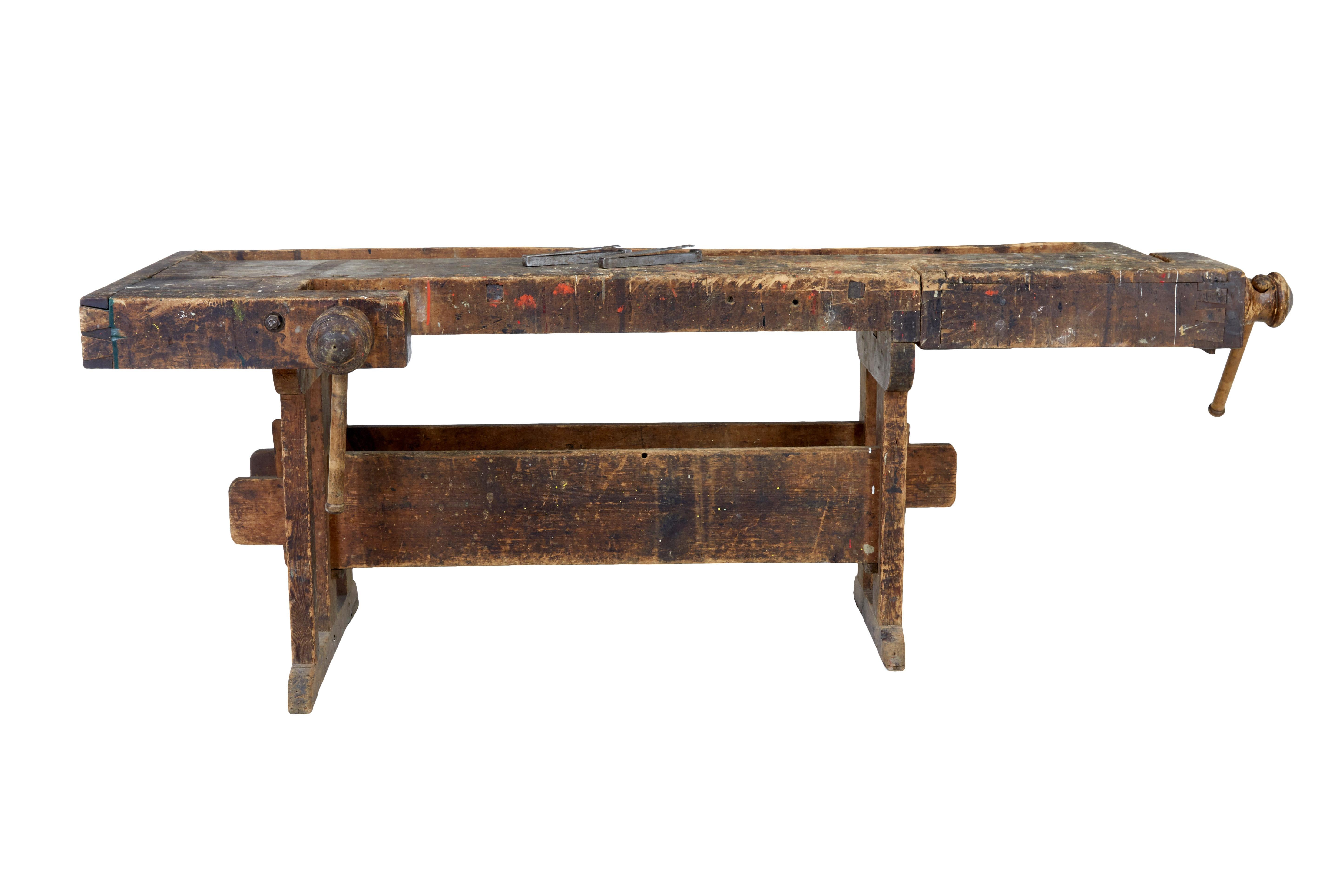 19th century Scandinavian pine workbench, circa 1890.

Here we have a fine example of a piece of working furniture which we purchased on our travels from around Sweden.

Typical l shaped bench, with rear trough.  Hand turned clamp to the left