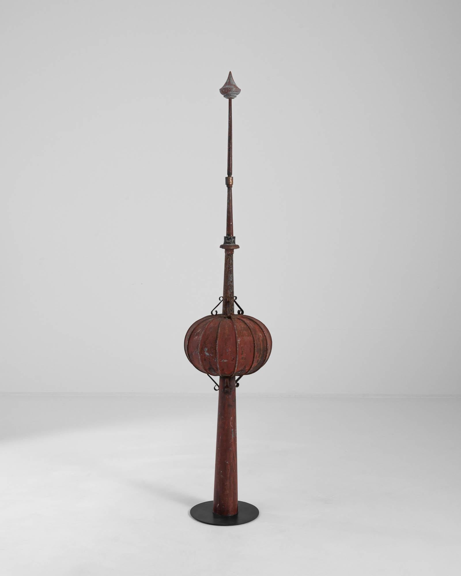 A metal weather vane created in 19th century Scandinavia. Resembling a spear-like pillar punctuated by a pumpkin shaped accent and an equestrian pendant, this Scandinavian totem formerly served as a functional architectural accent, pointing the
