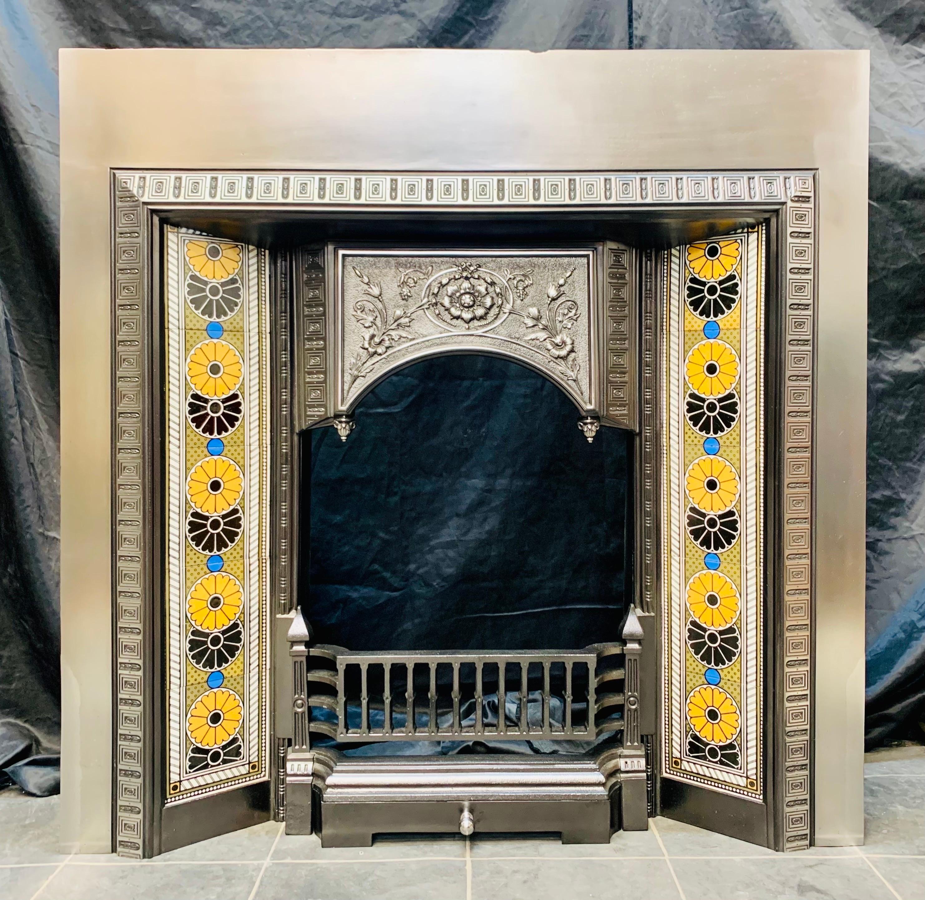 A large 19th century Scottish Carron of Falkirk cast iron fireplace insert with geometric side tiles. A generous polished outer plate with a raised cast front, a beautiful set of Minton tiles with geometric circles displaying bold colours to each