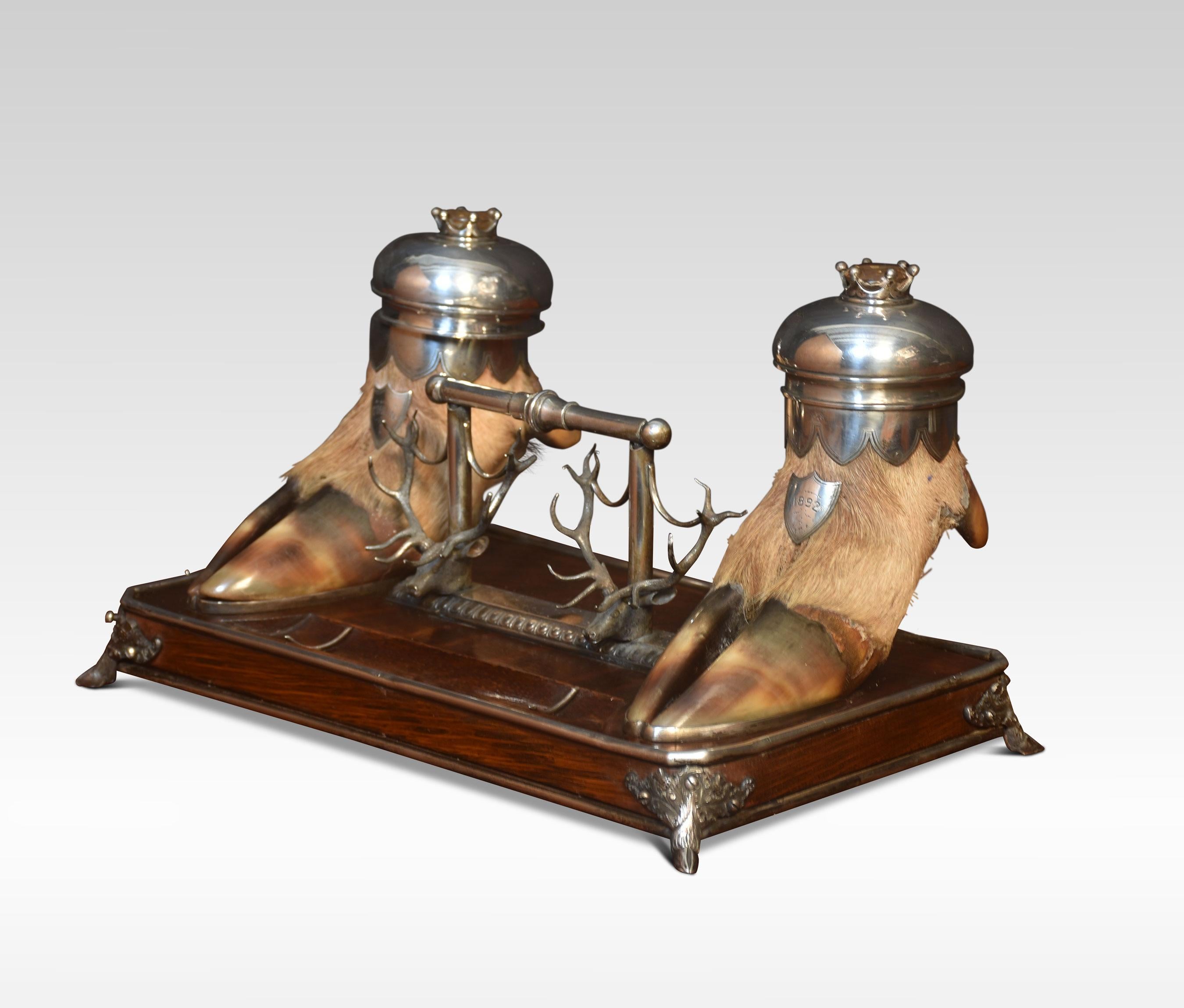 19th century Scottish double inkwell by Arthur Medlock with two hoof inkwells with metal covers centred by a facet citrine, on a wooden base, the inkwells stamped Medlock Inverness.
Dimensions
Height 7 inches
Width 12.5 inches
Depth 7.5 inches.