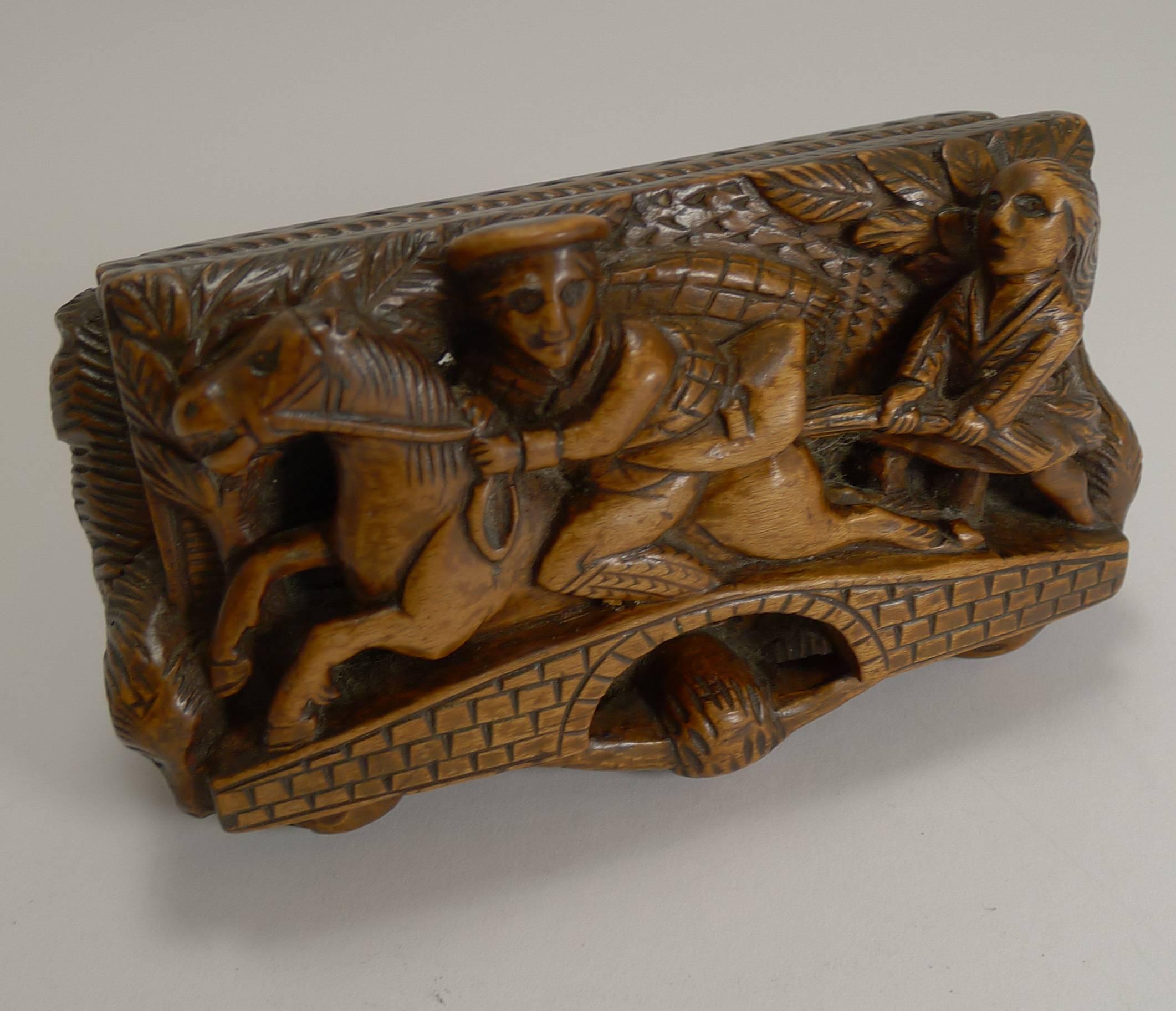 A magnificent hand-carved Scottish table snuff box.

The hinged lid is carved with Tam O'Shanter riding over the bridge over the Doon with the witch in pursuit, the thumbpiece a bull's head above two rams, the sides with recumbent