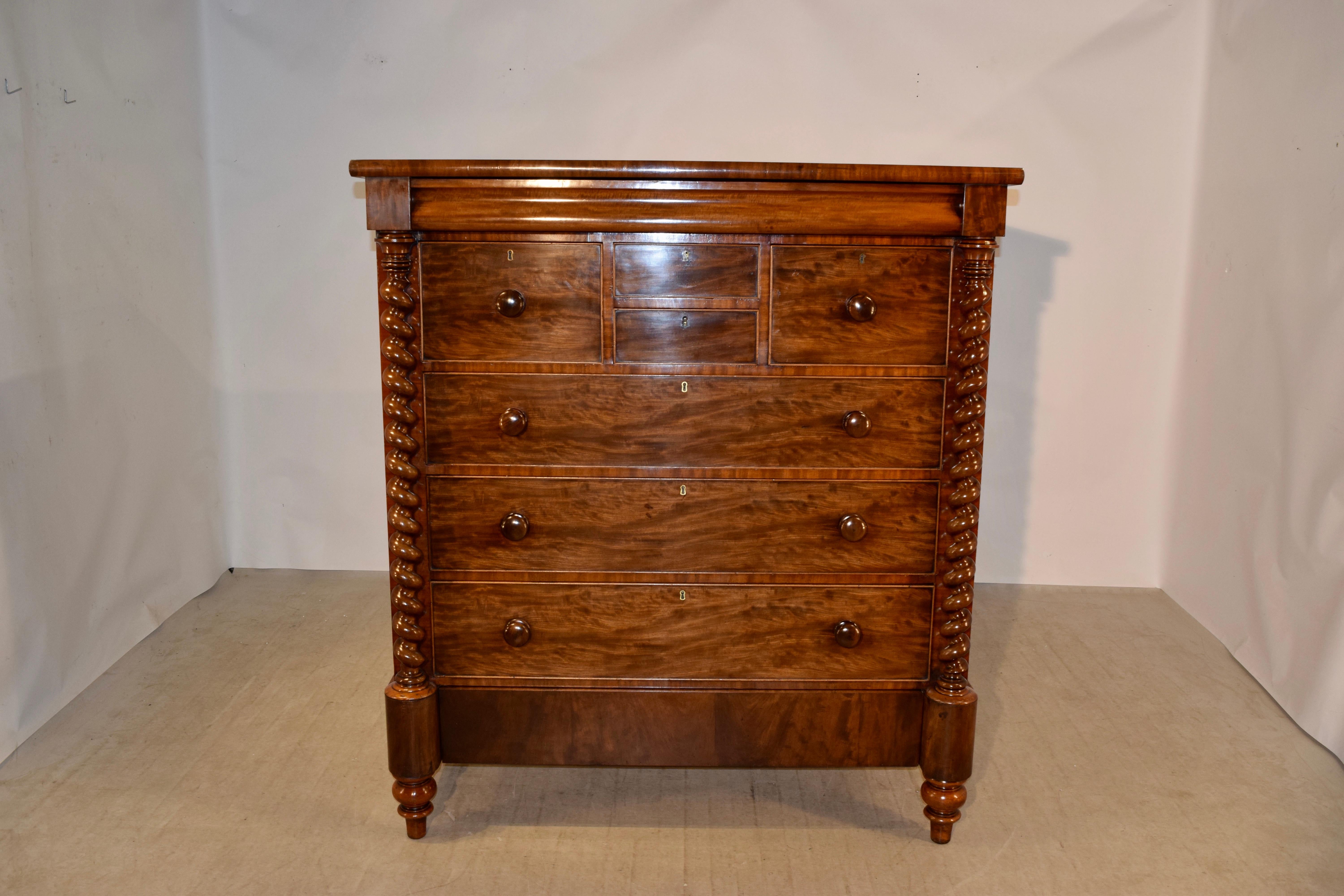19th century large chest of drawers from Scotland made from mahogany. The top has a domed edge following down to a lovely serpentine shaped molding, which is a hidden drawer. At the top of the chest, there are two central small drawers, flanked by