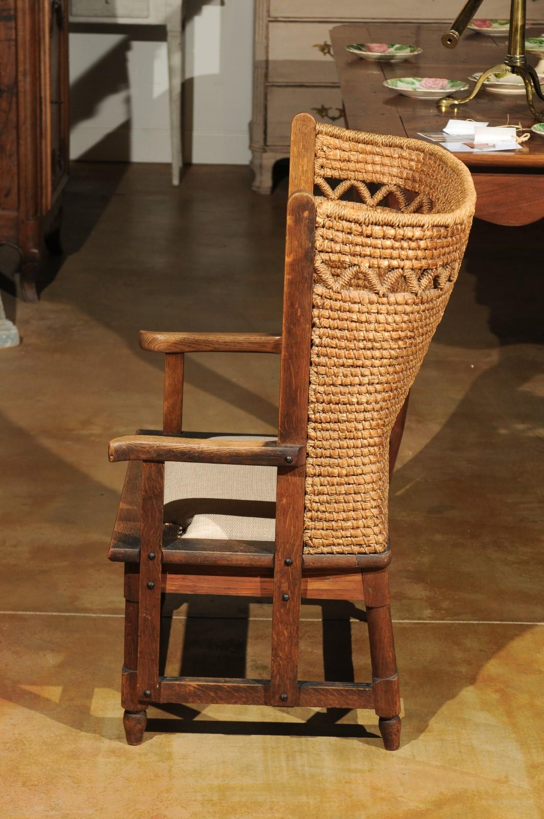 An authentic 19th century Orkney chair with zigzag-patterned handwoven straw back from the Island of Orkney near the Northern tip of Scotland and new woven upholstery. This armchair features a wooden armature supporting a curved back, reminiscent of