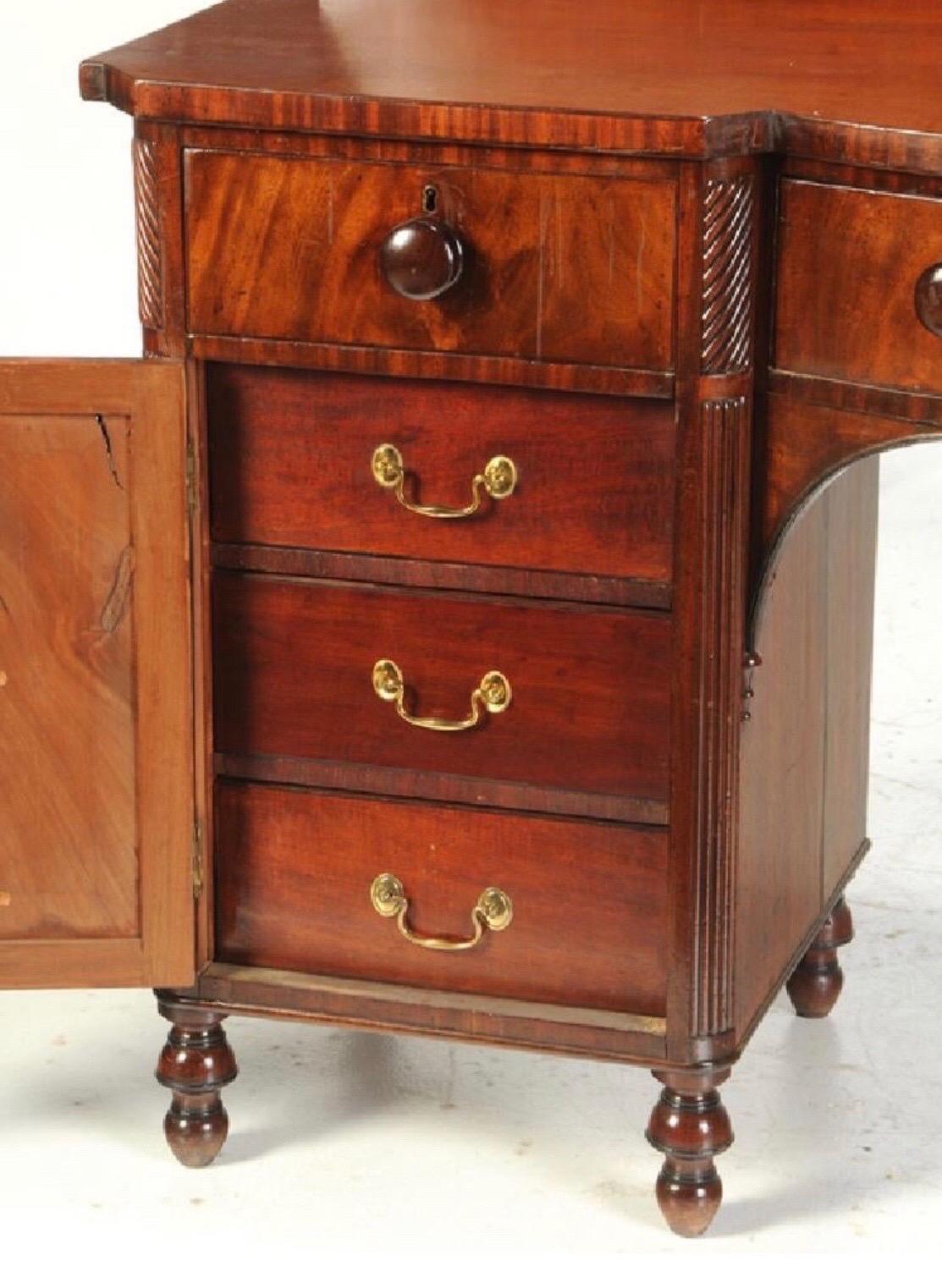 19th century Scottish regency mahogany sideboard. Rich, nice color mahogany with three frieze drawers over two cabinet doors that open to 6 additional drawers- 3 on each side. 



  