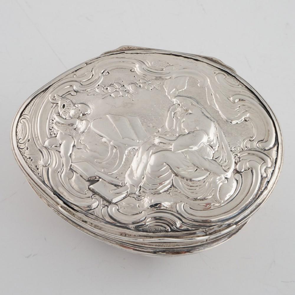 Heading : Georgian cowrie shell snuff box
Date : c1820
Period : George III / Regency
Origin :  Almost certainly Scottish provincial
Decoration : Hinged silver cover with repousse and chased design depicting a woman reading in a garden. Along with