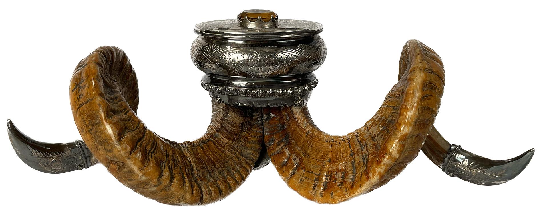 A late 19th century Scottish silver-plated ram horn snuff mull with oval cairngorm gem on lid and Walker & Hall (Sheffield, England) silver mark on lid.

Dimensions: 7.5